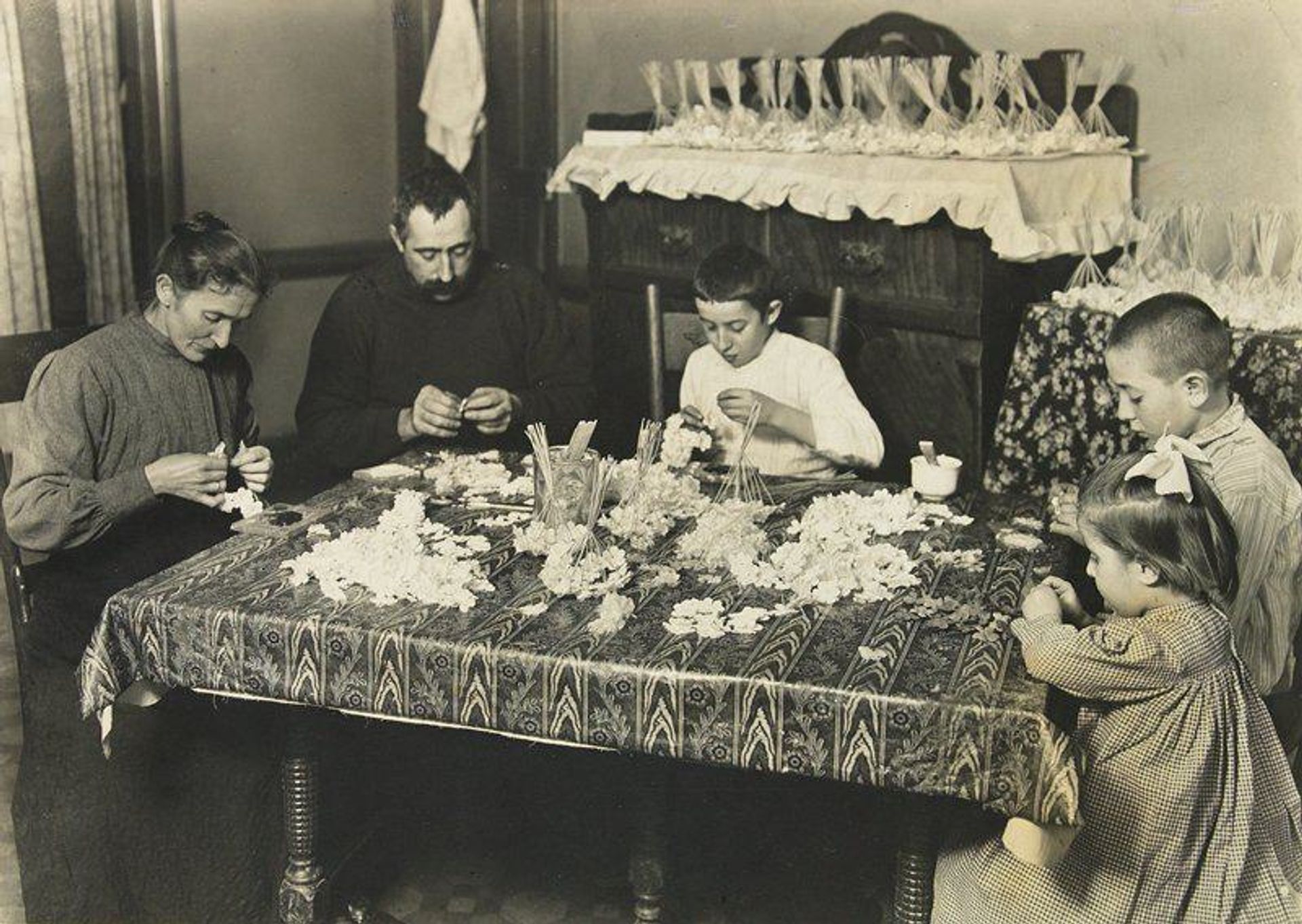 Family Making Artificial Flowers by Lewis Hine