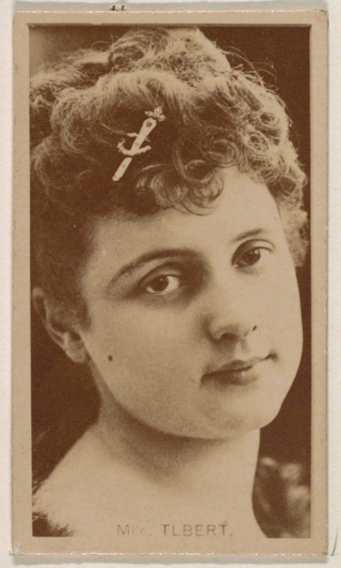 Mlle. Tlbert, from the Actresses series (N245) issued by Kinney Brothers to promote Sweet Caporal Cigarettes by Kinney Brothers Tobacco Company