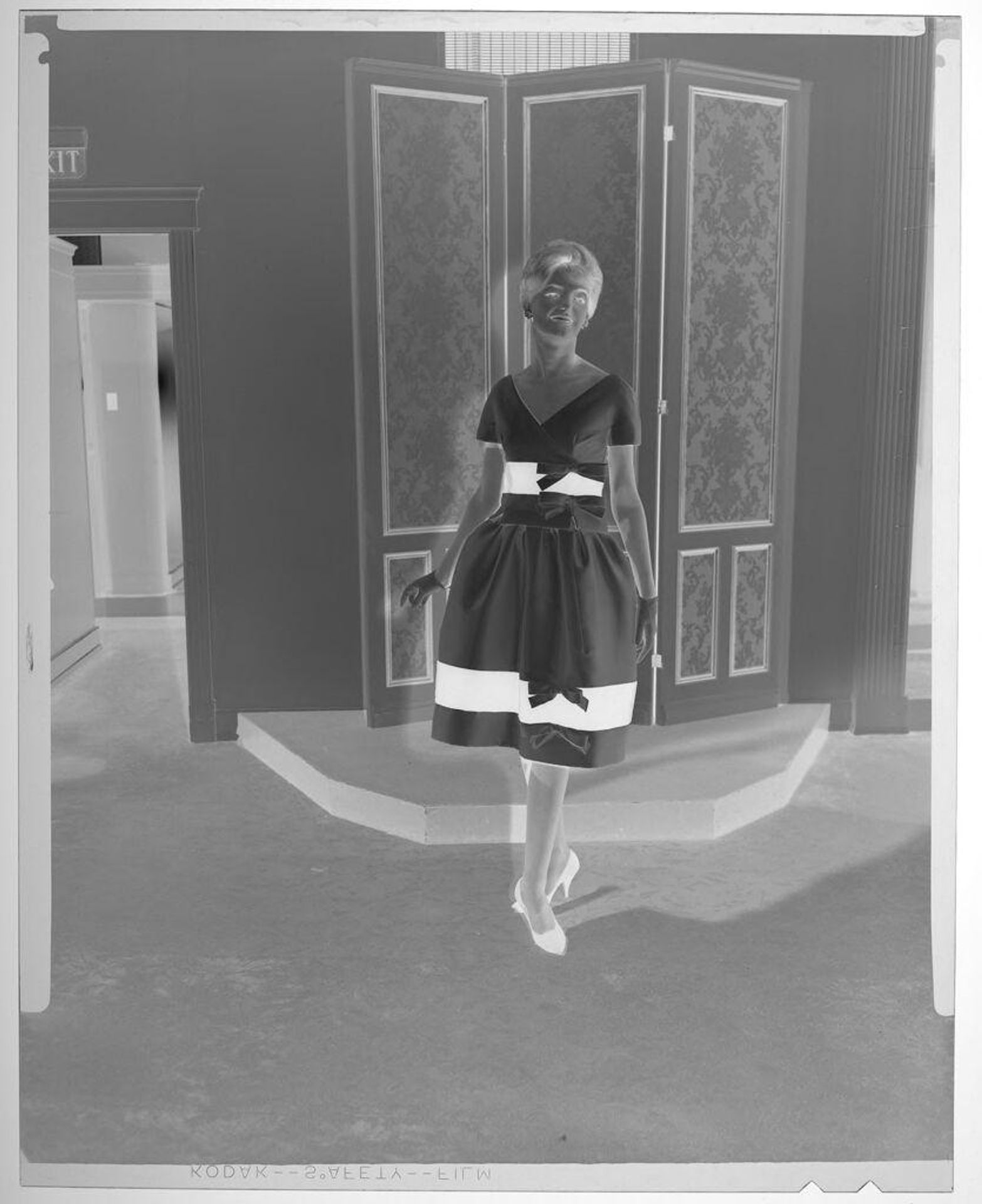 Untitled (fashion portrait of woman in formal dress with bows and two black stripes) by Martin Schweig
