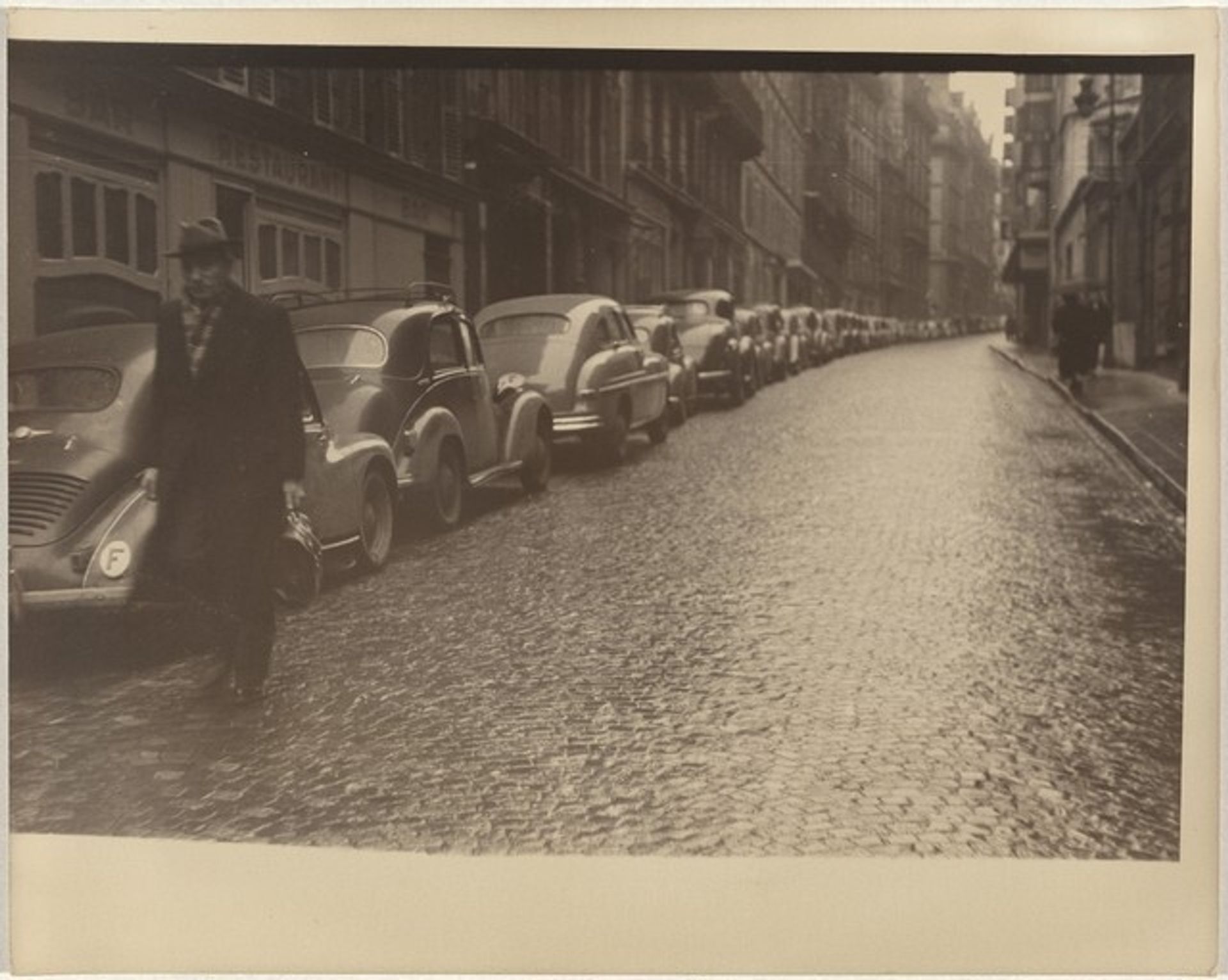 Car lined street, Paris by Robert Frank