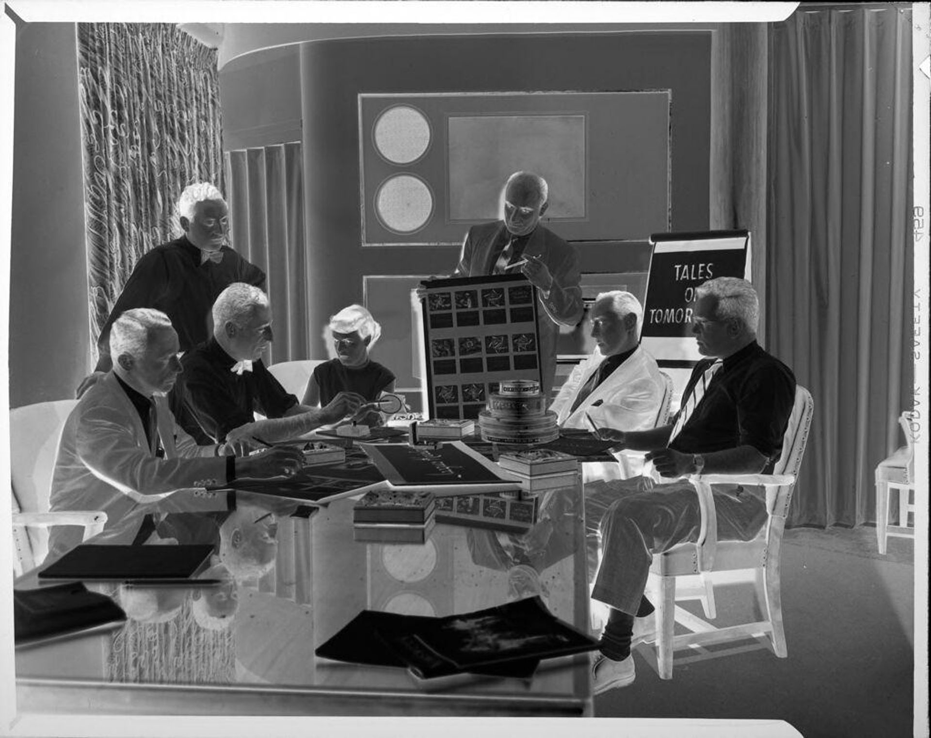 Untitled (advertising executives at meeting around table) by Peter James Studio