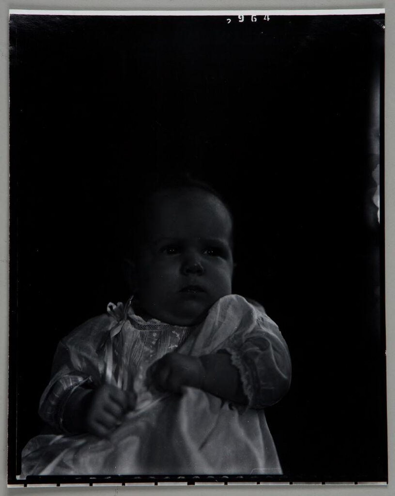 Untitled (baby sitting up, looking to side) by Paul Gittings
