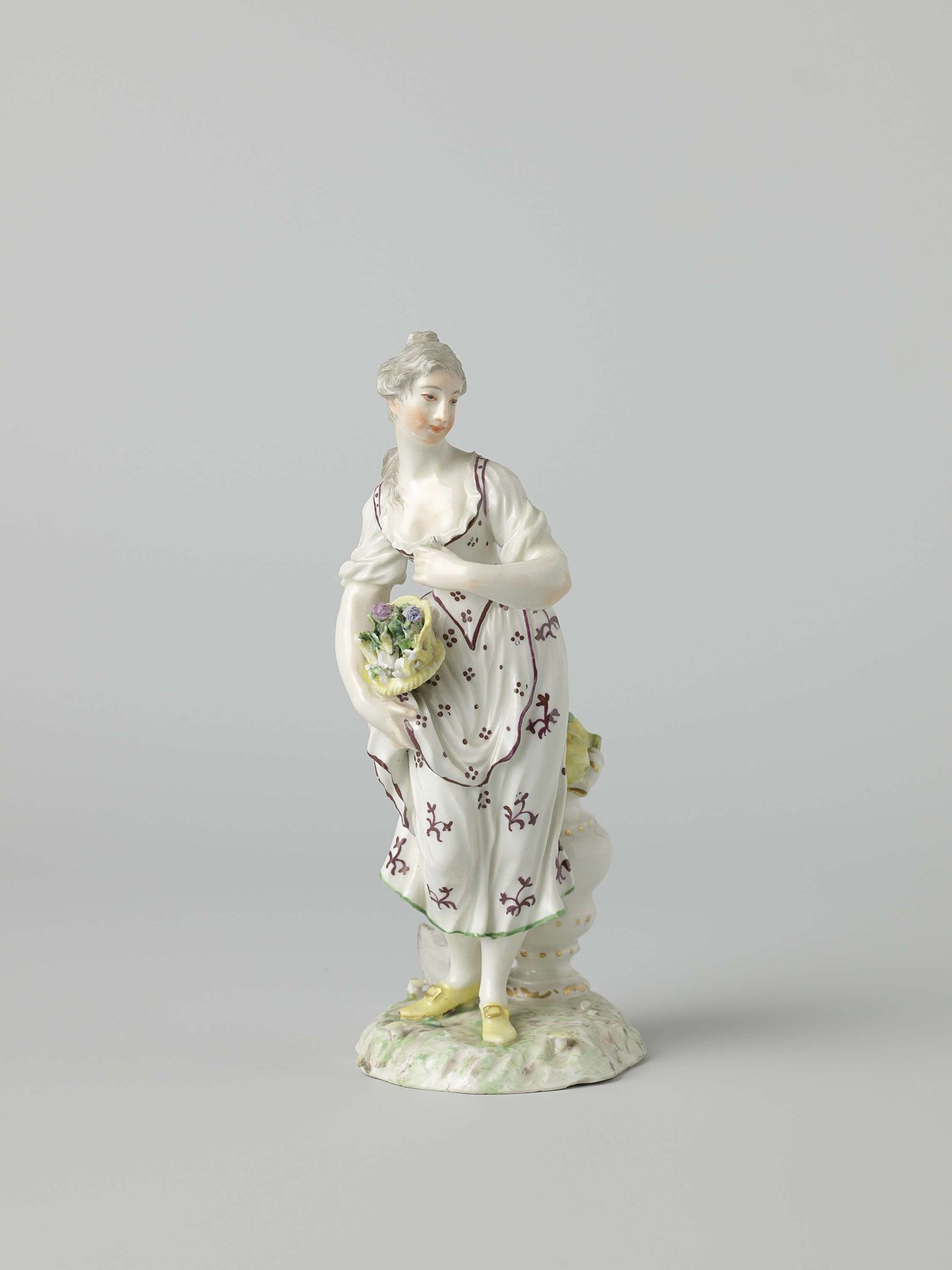 Figure of a woman with a flower basket by Porseleinfabriek Ludwigsburg