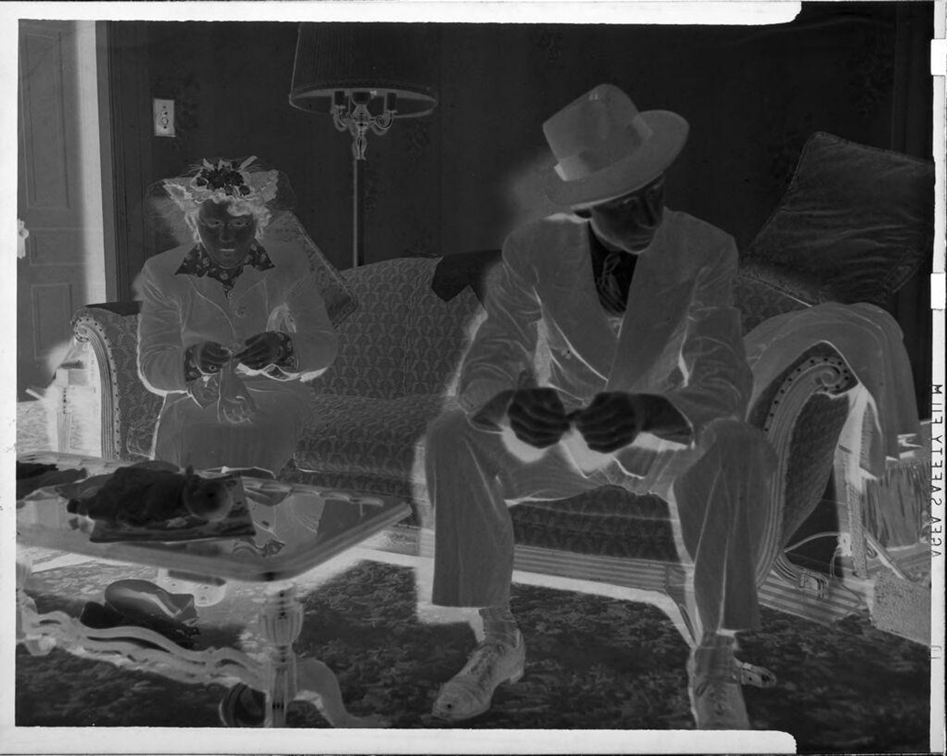 Untitled (man and woman on couch) by John Deusing