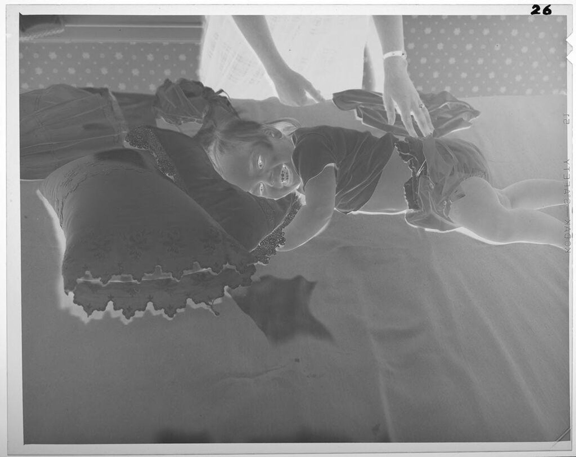 Untitled (baby lying on bed with pillow) by Lucian and Mary Brown