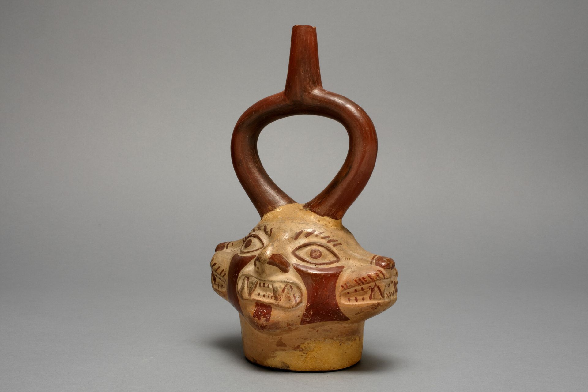 Stirrup Vessel in the Form of Multi-Headed Feline Being by Moche