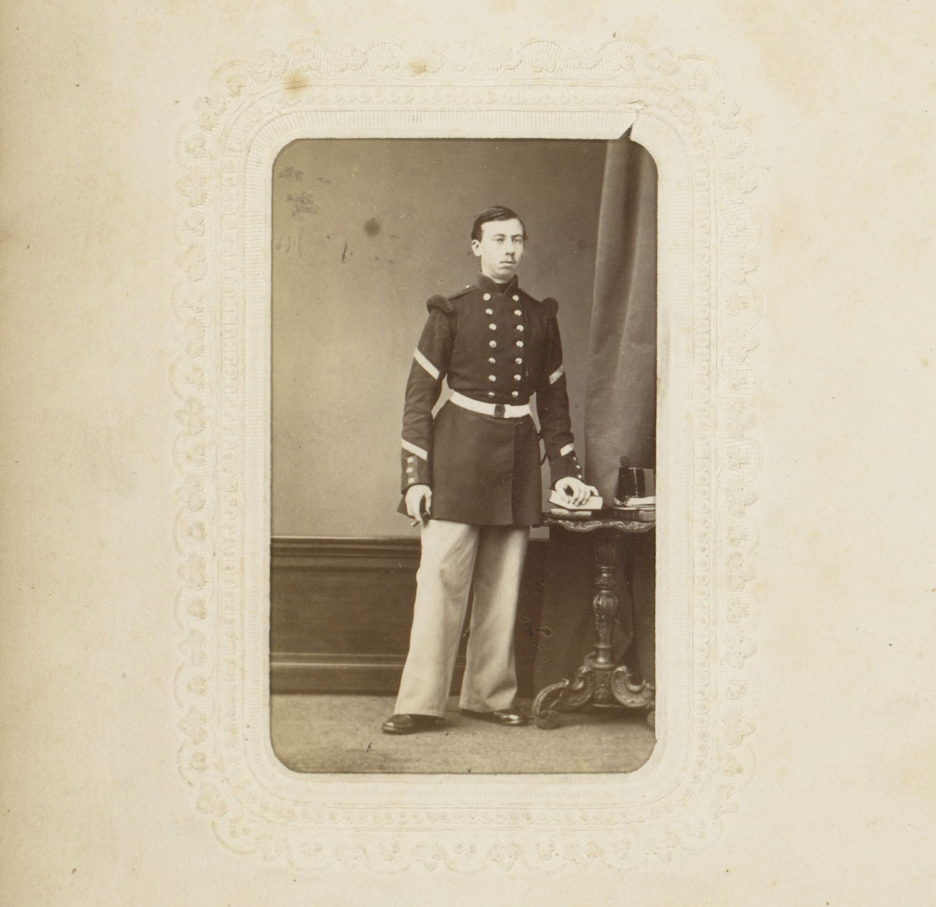 Portret van een jongeman in uniform met sigaar en boek by Trumper Frères
