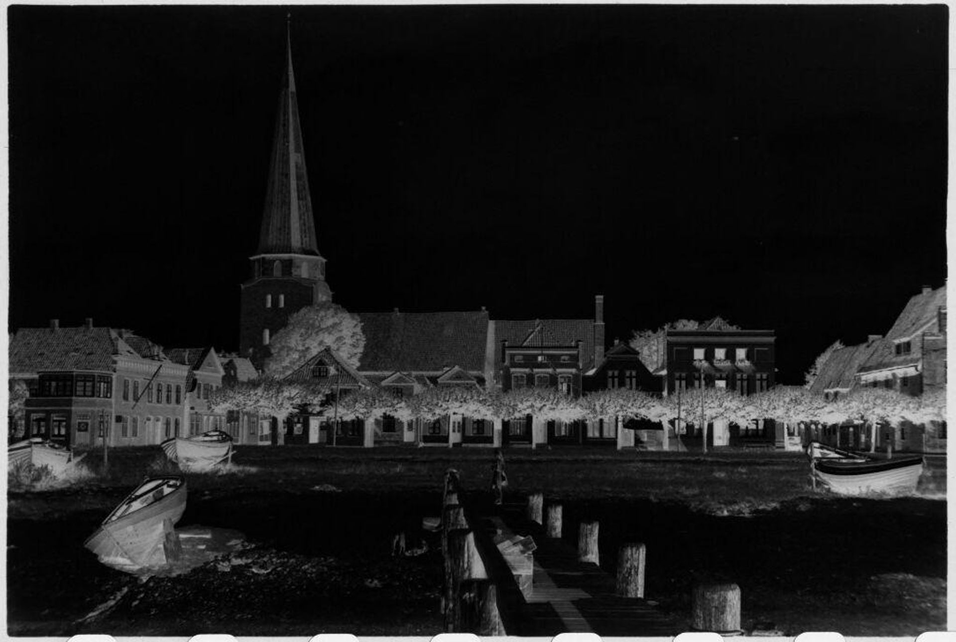 [Beach, dock with church in background, near LÃ¼beck] by attributed to Laurence Feininger