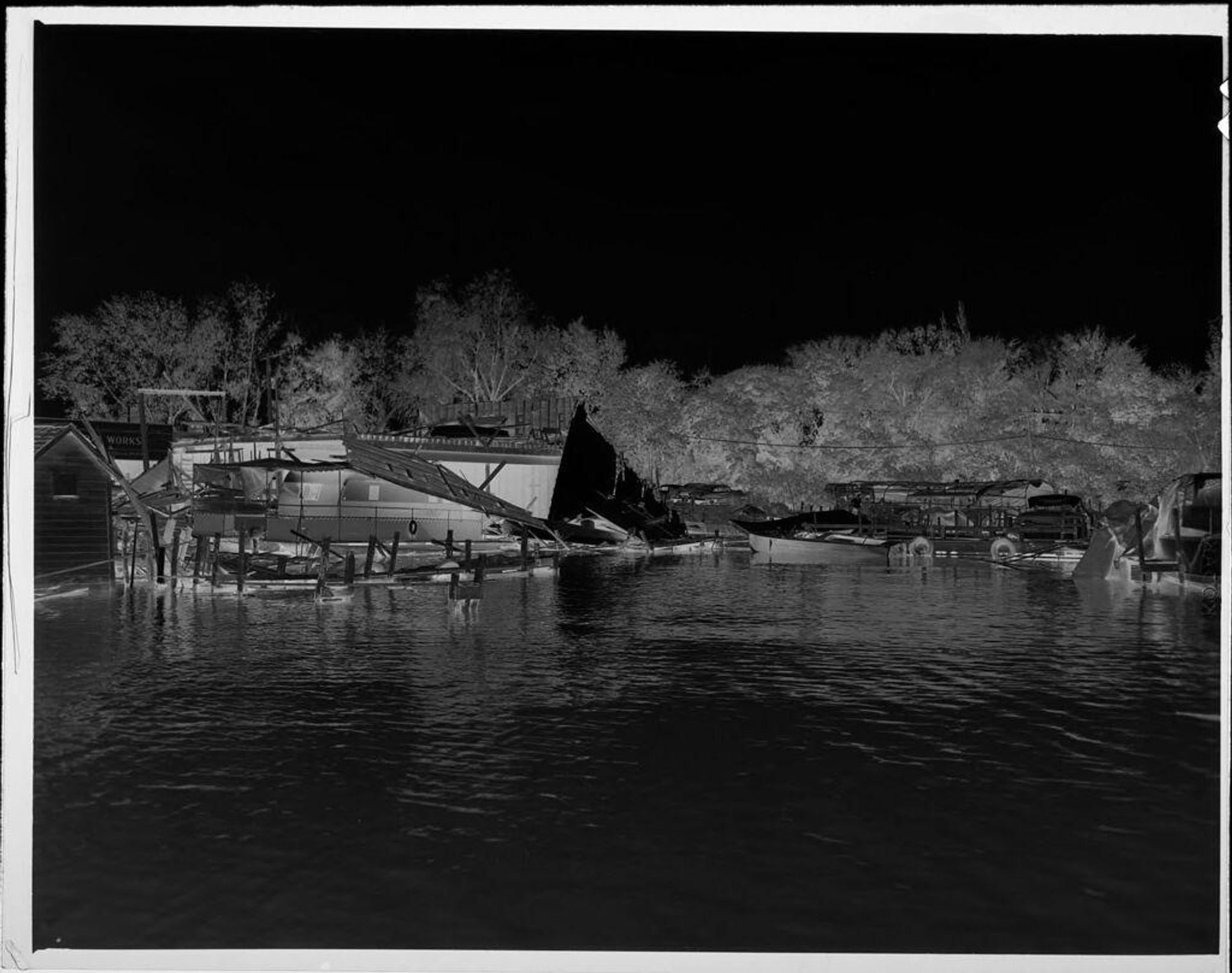 Untitled (boat docks damaged in storm) by Lucian and Mary Brown