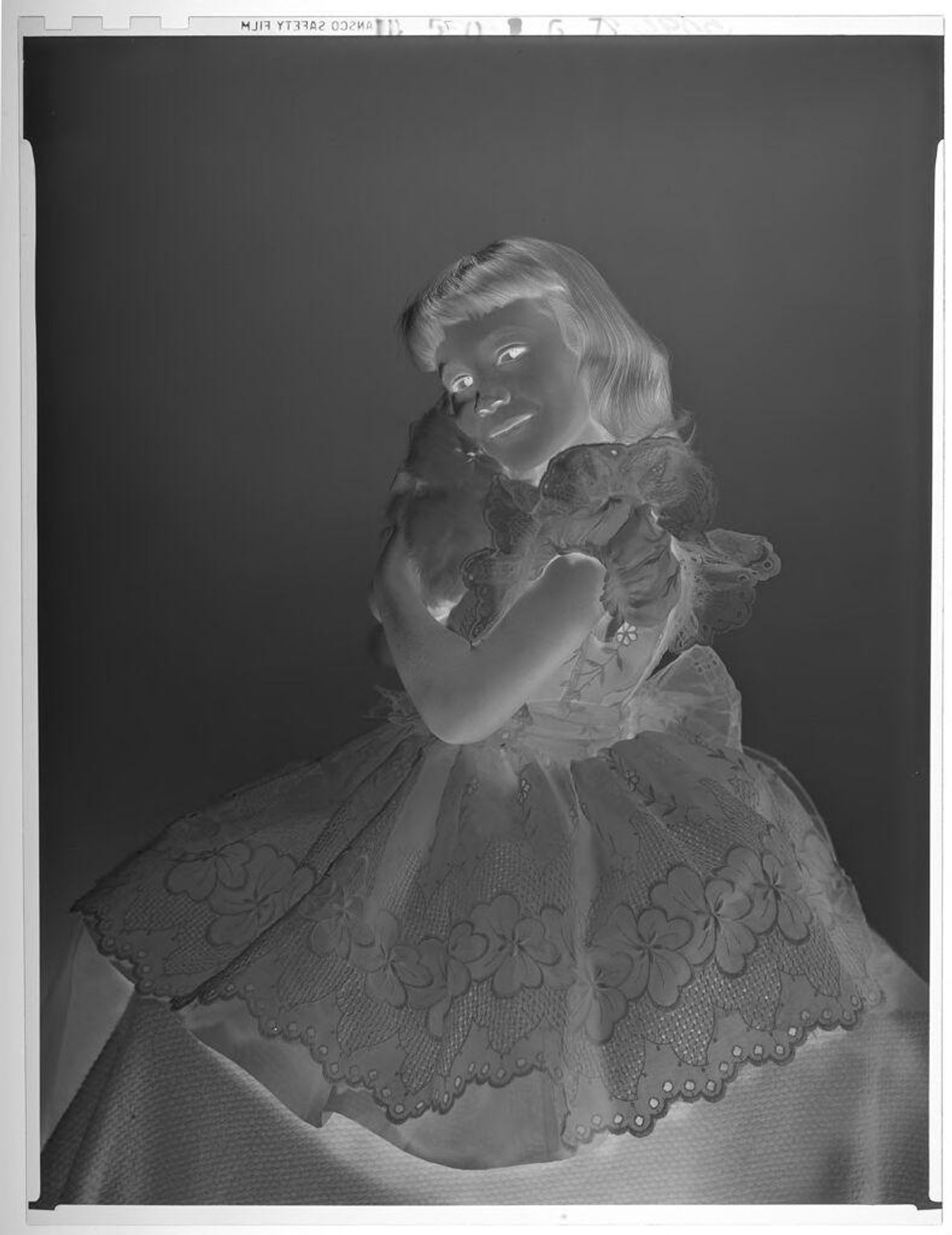 Untitled (portrait of girl in lacy dress embracing cat) by Paul Gittings