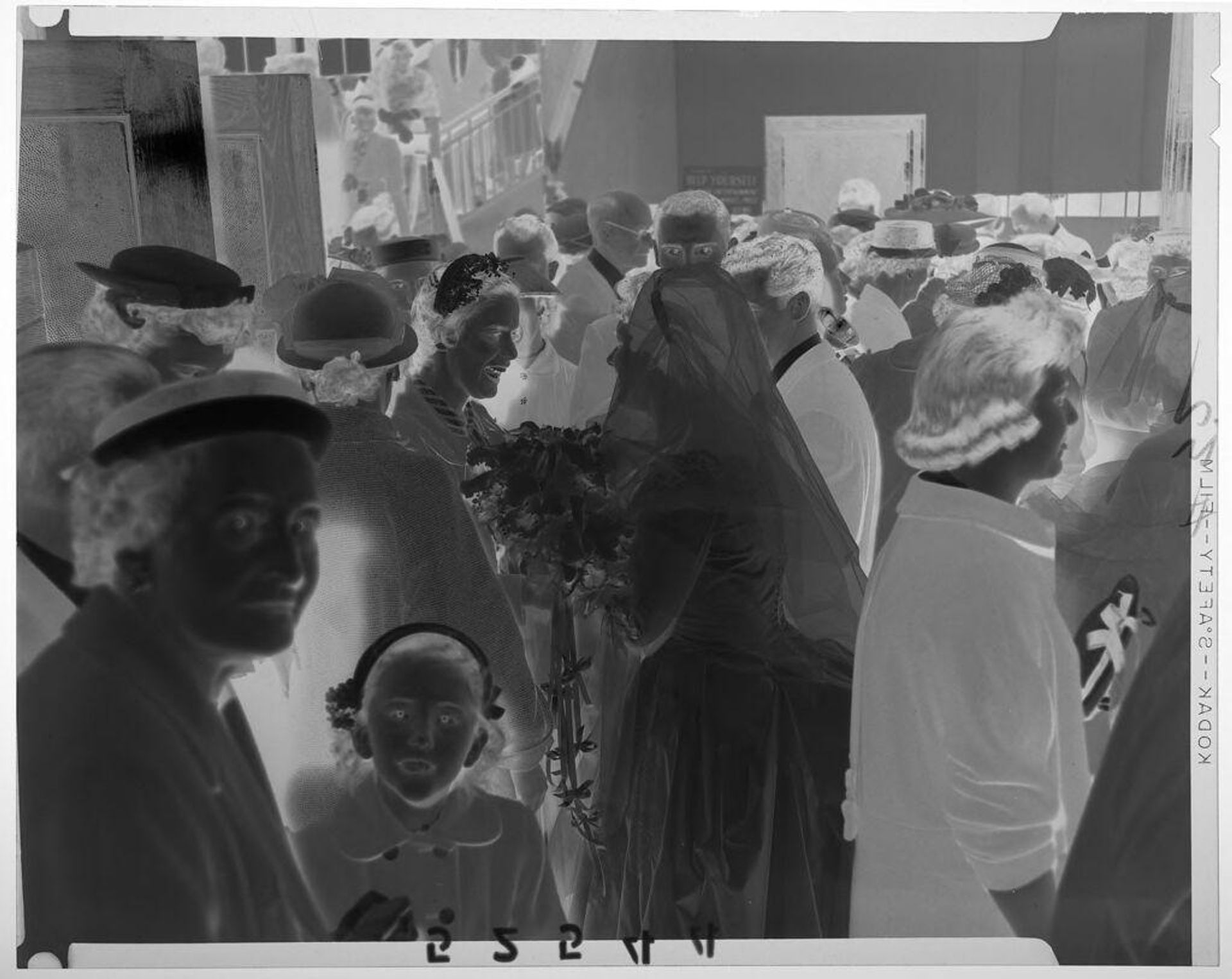 Untitled (bride chatting with woman in large room filled with people) by Martin Schweig