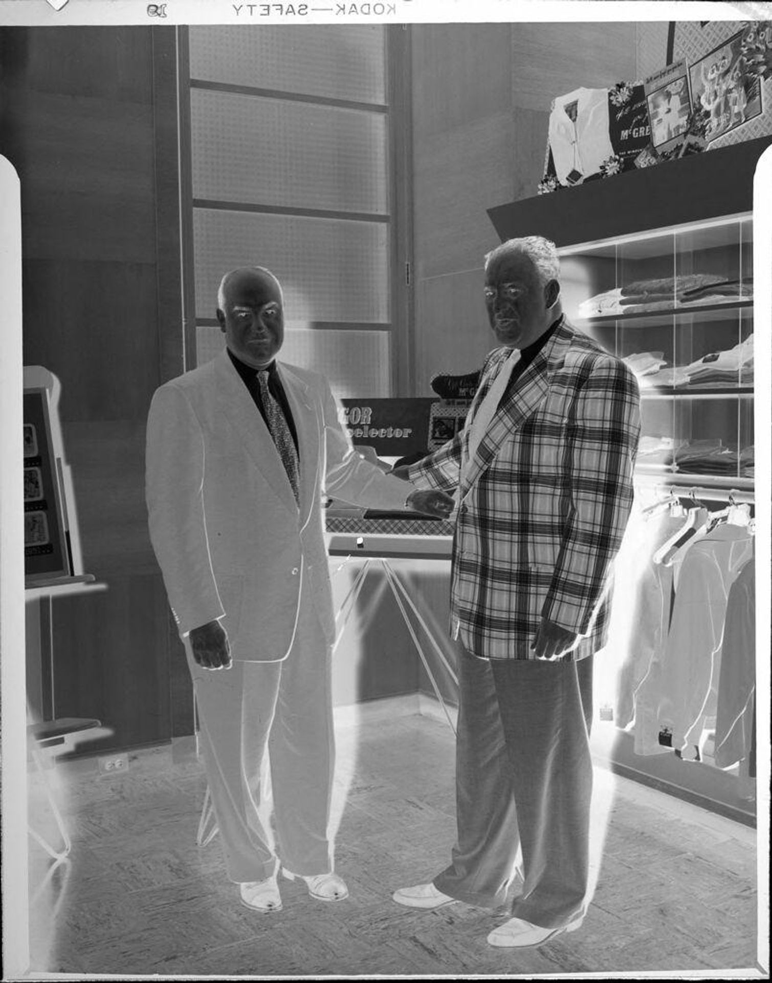 Untitled (two men, one in plaid coat) by Peter James Studio
