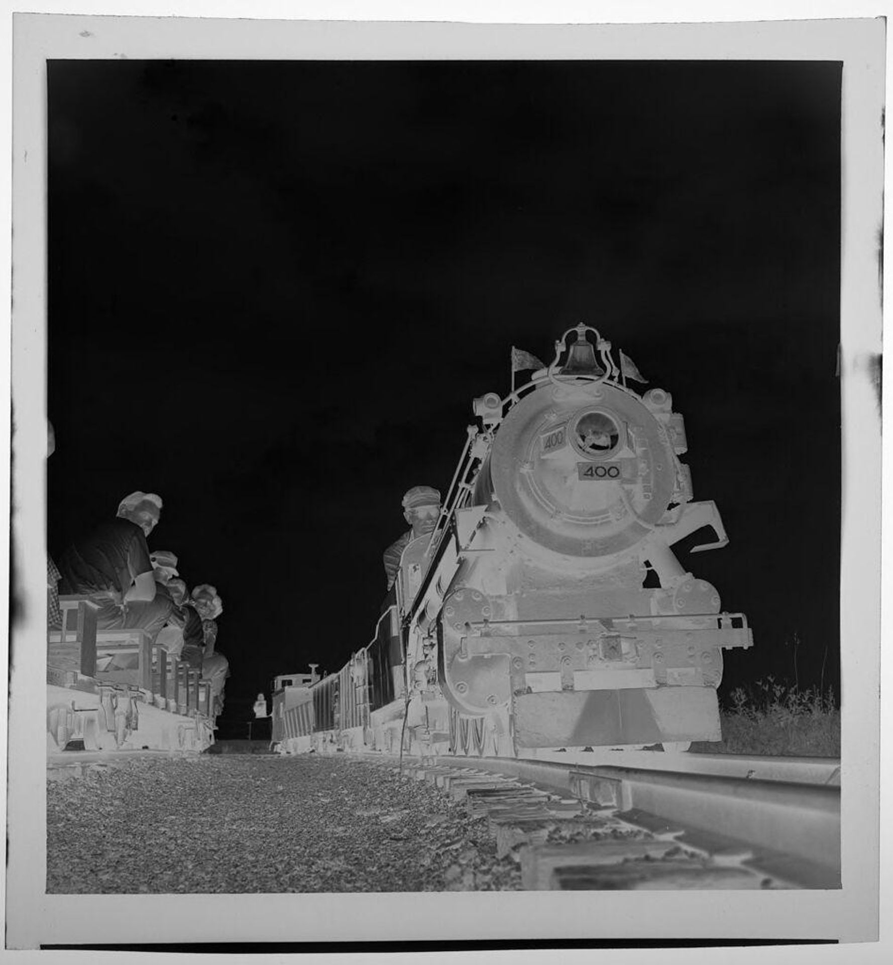 Untitled (mini train on tracks, seen from ground level) by Jack Gould