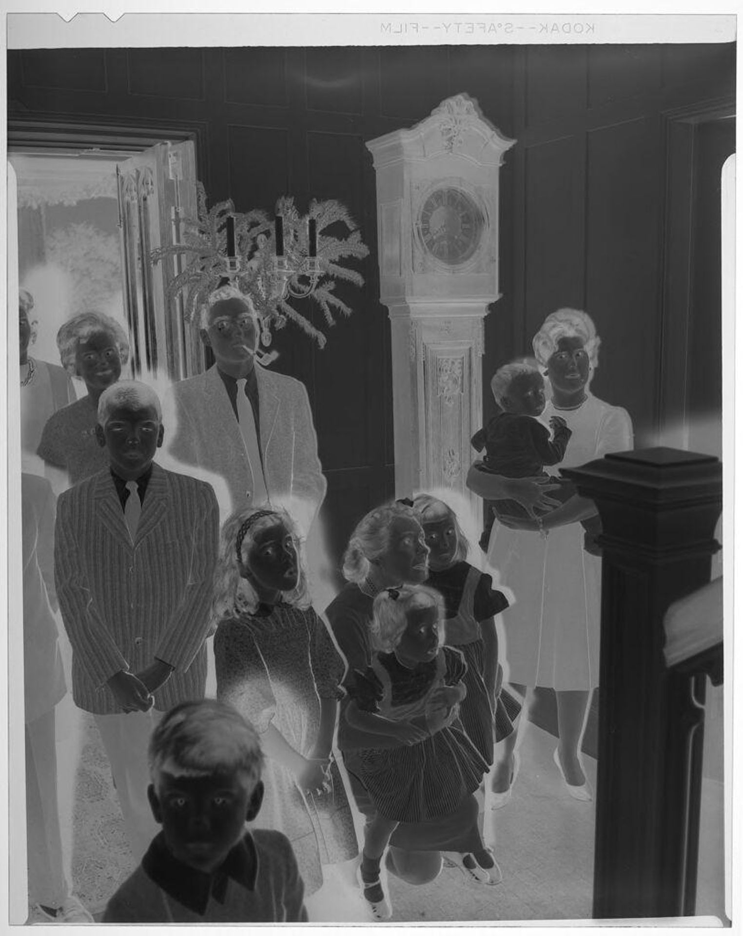 Untitled (children and adults gathered at bottom of staircase while looking up) by Martin Schweig