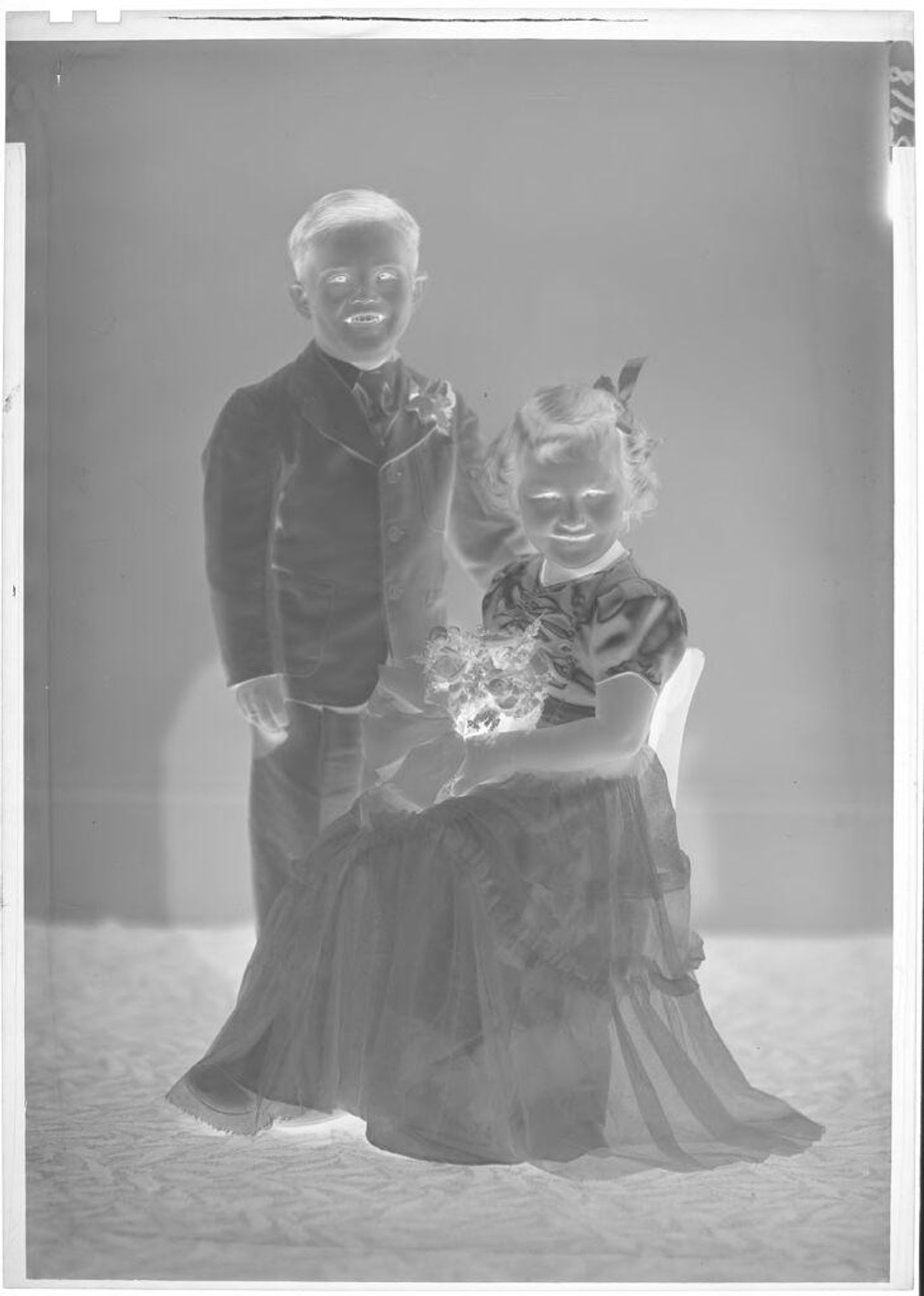 Untitled (portrait of boy and girl in studio) by John Deusing