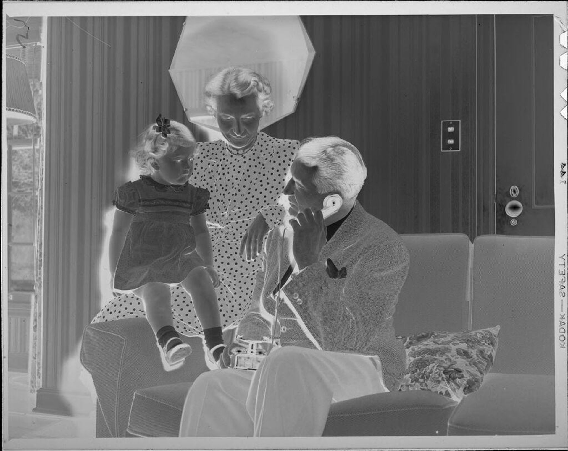 Untitled (woman and child with man on telephone) by Lucian and Mary Brown