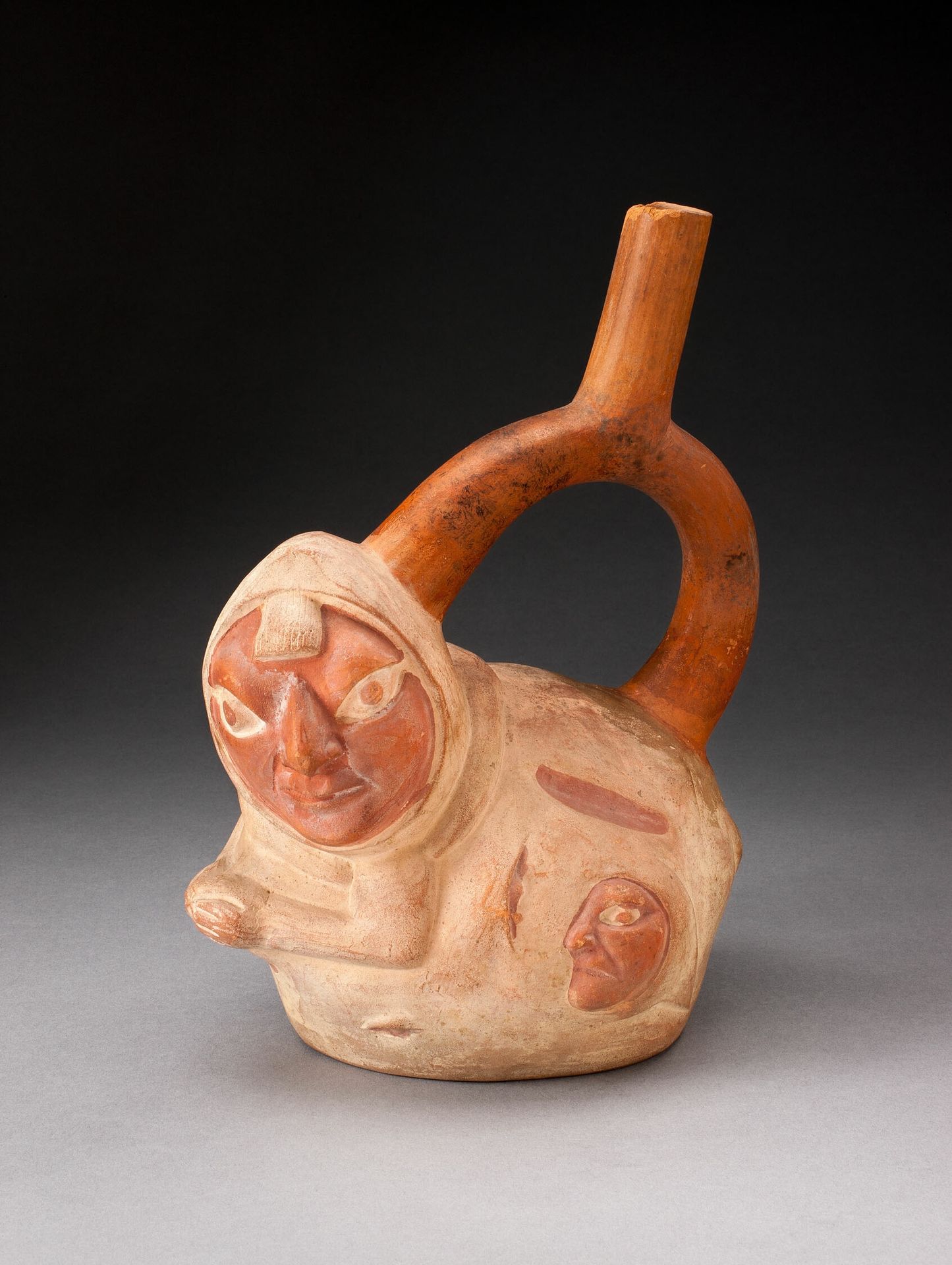 Handle Spout Vessel in the Form of a Crouching Figure with Human Heads Attached to Side by Moche