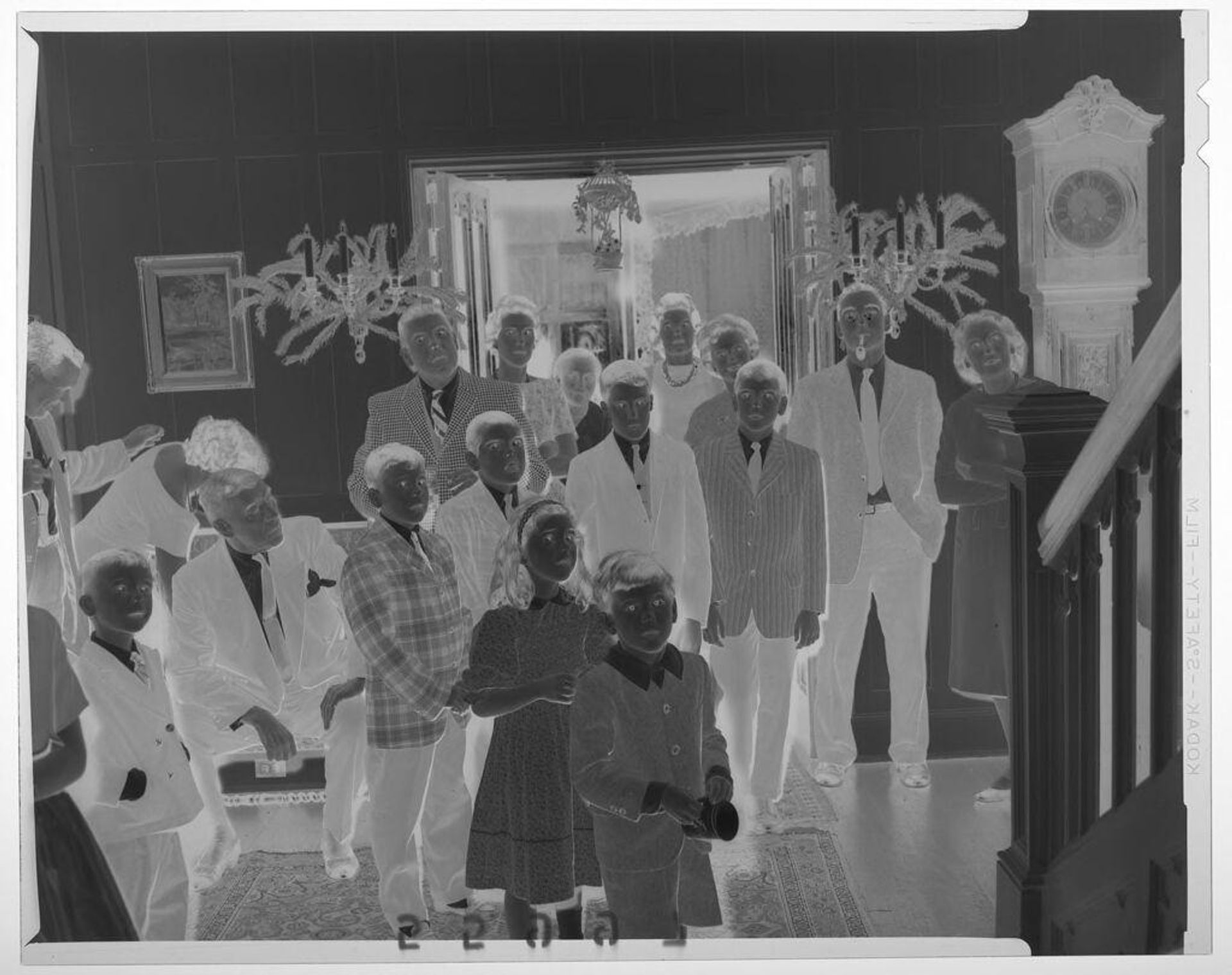 Untitled (large group of children and adults standing at bottom of staircase looking up) by Martin Schweig