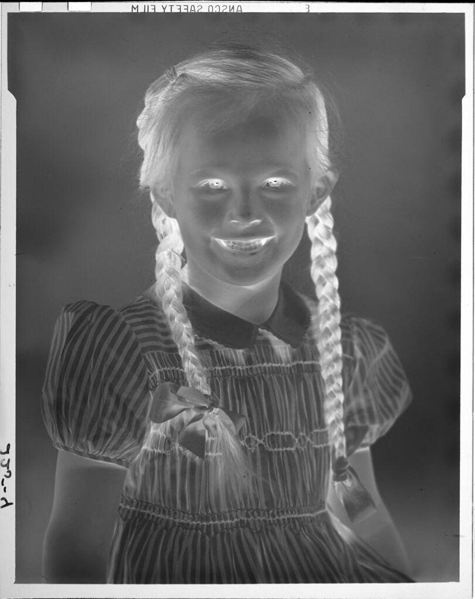 Untitled (portrait of little girl with hair in braids) by John Howell