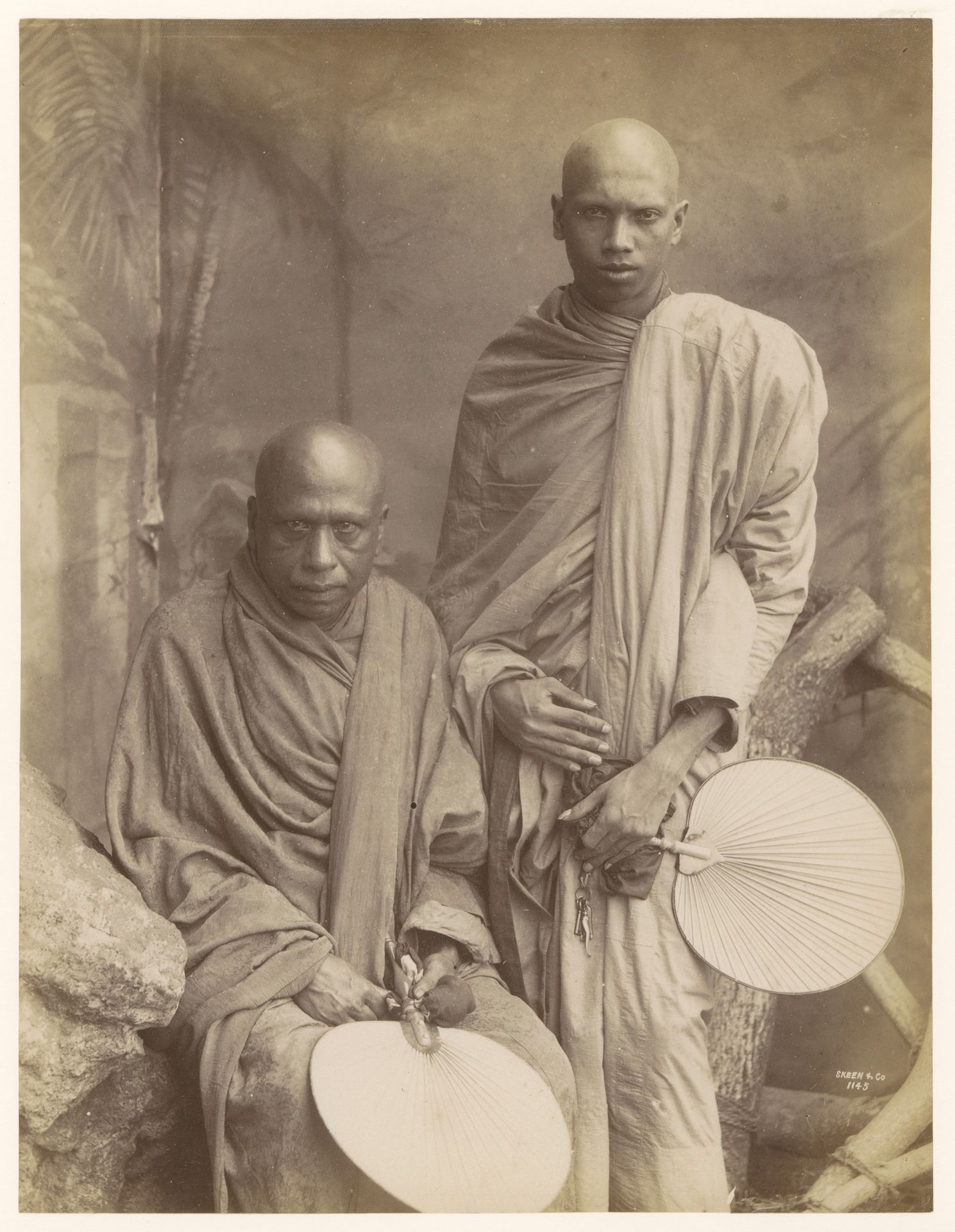 Studio portrait of two unknown Buddhist monks, Sri Lanka by W.L.H. Skeen & Co.
