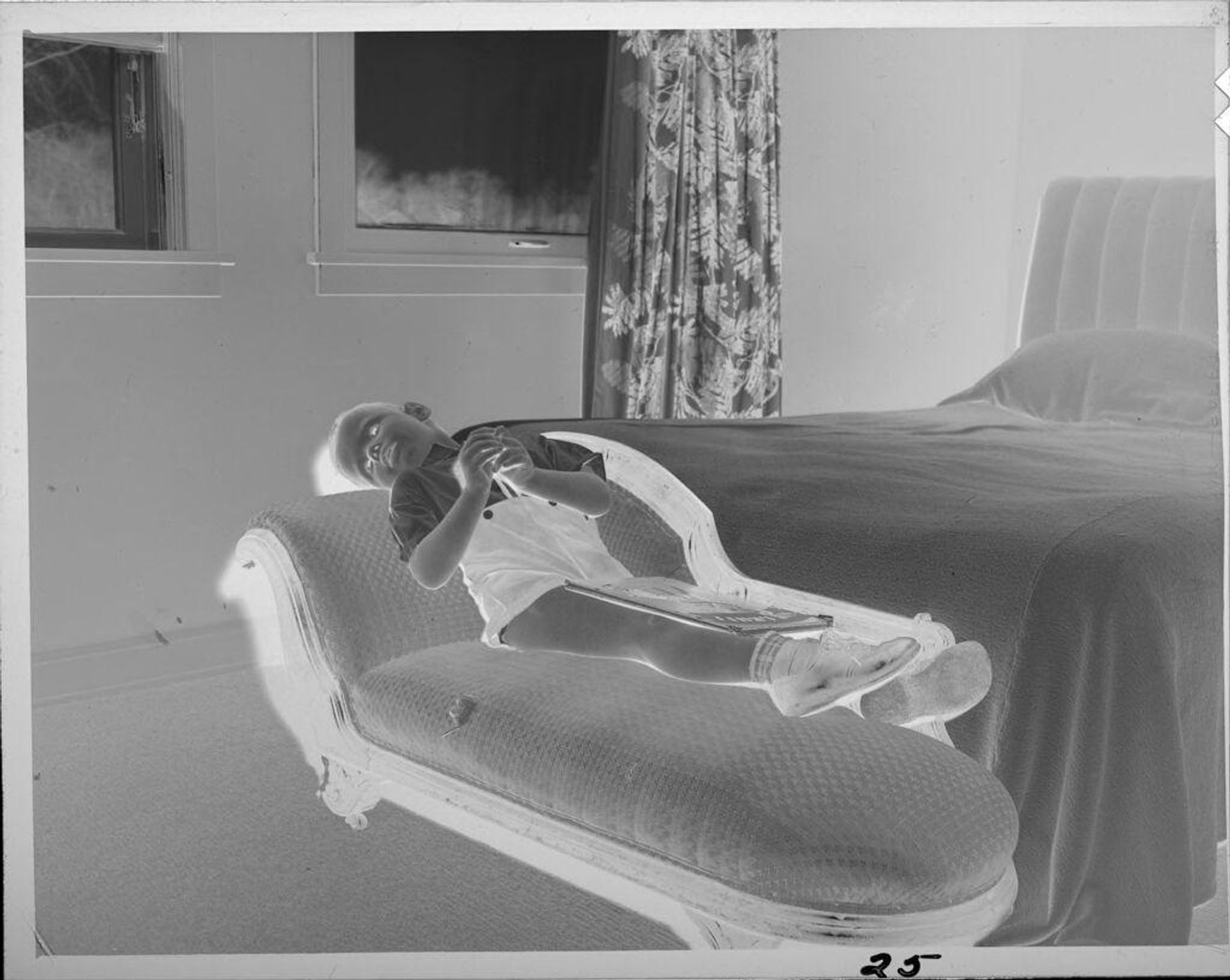 Untitled (little boy lying on chaise) by Lucian and Mary Brown