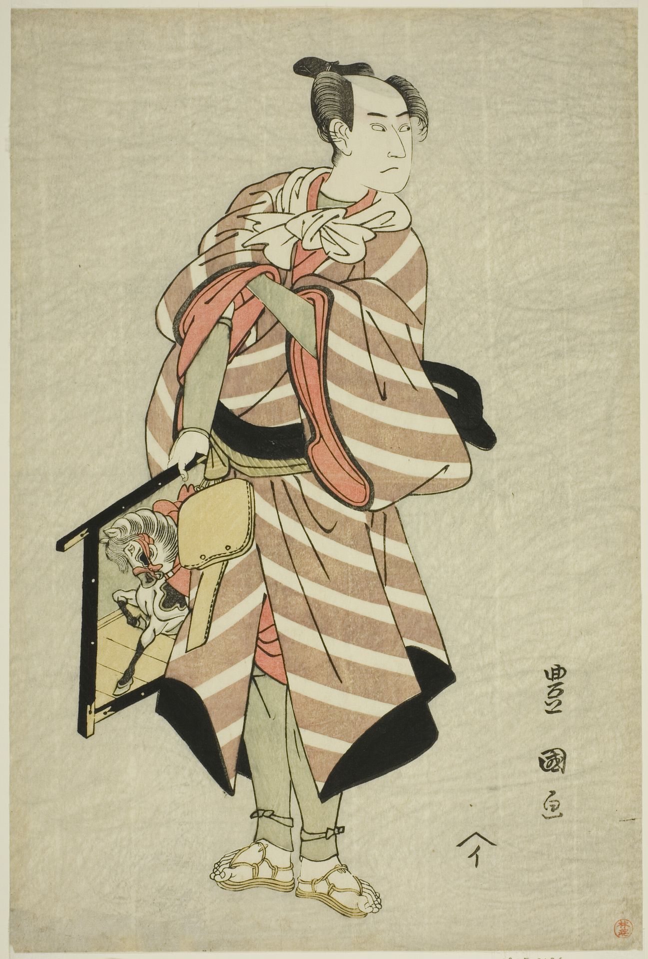The actor Sawamura Sojuro III as the packhorse-man Muchizo in the play "Miyamairi Musubi no Kamigaki," performed at the Kiri Theater in the eleventh month, 1797 by Utagawa Toyokuni I