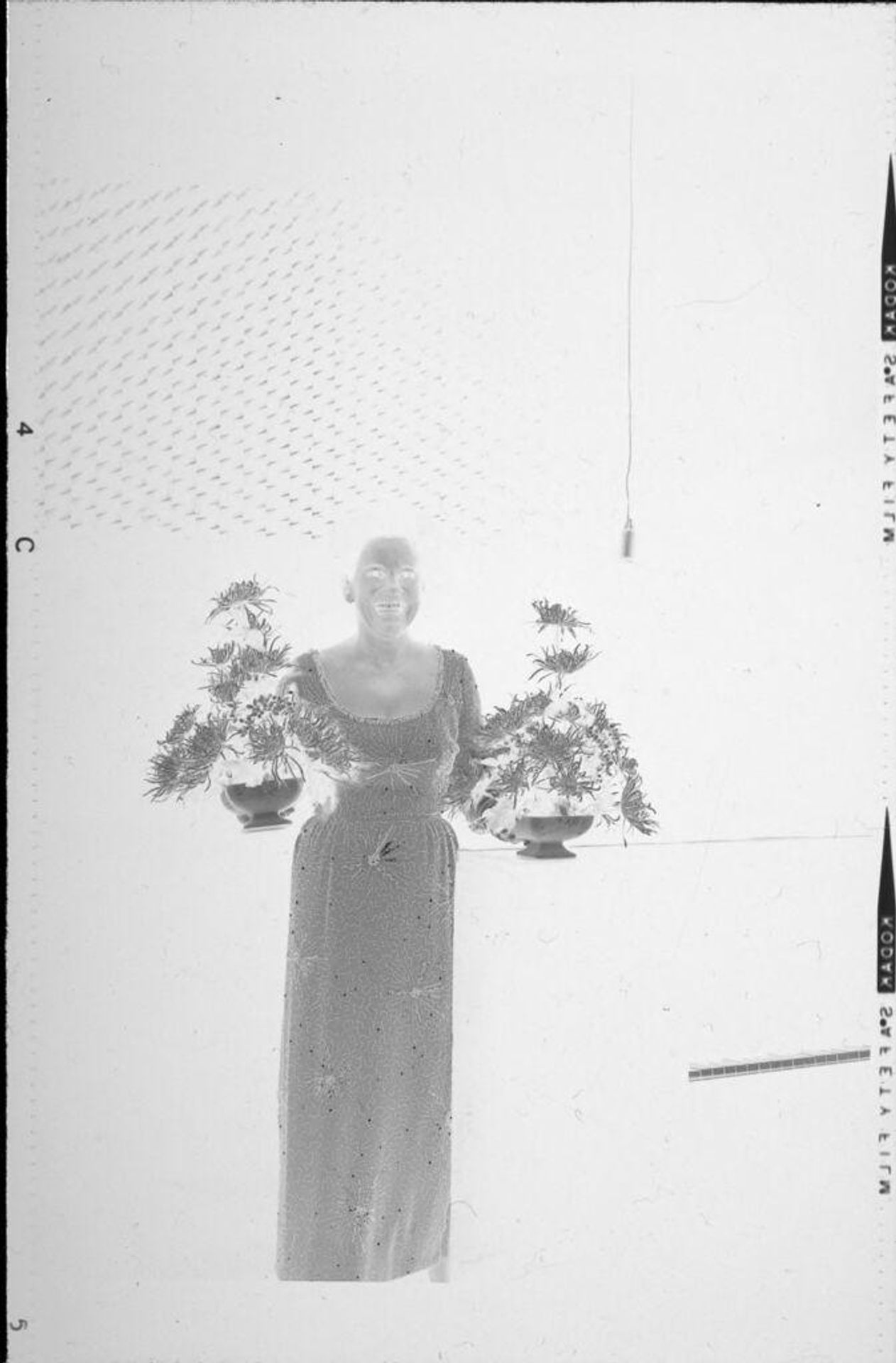 Untitled (woman holding flower centerpieces) by Robert Burian
