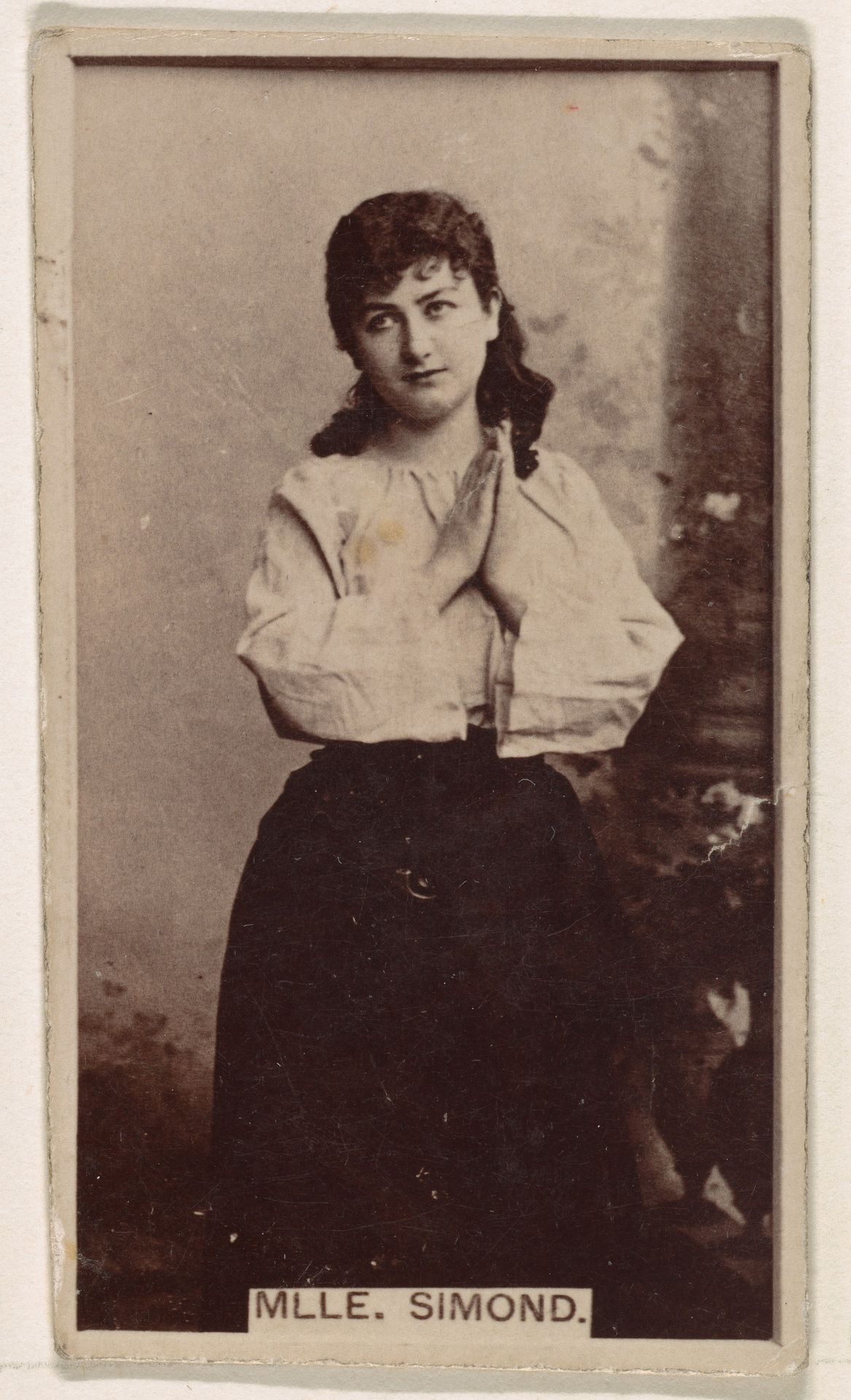 Mlle. Simond, from the Actresses series (N245) issued by Kinney Brothers to promote Sweet Caporal Cigarettes by Kinney Brothers Tobacco Company