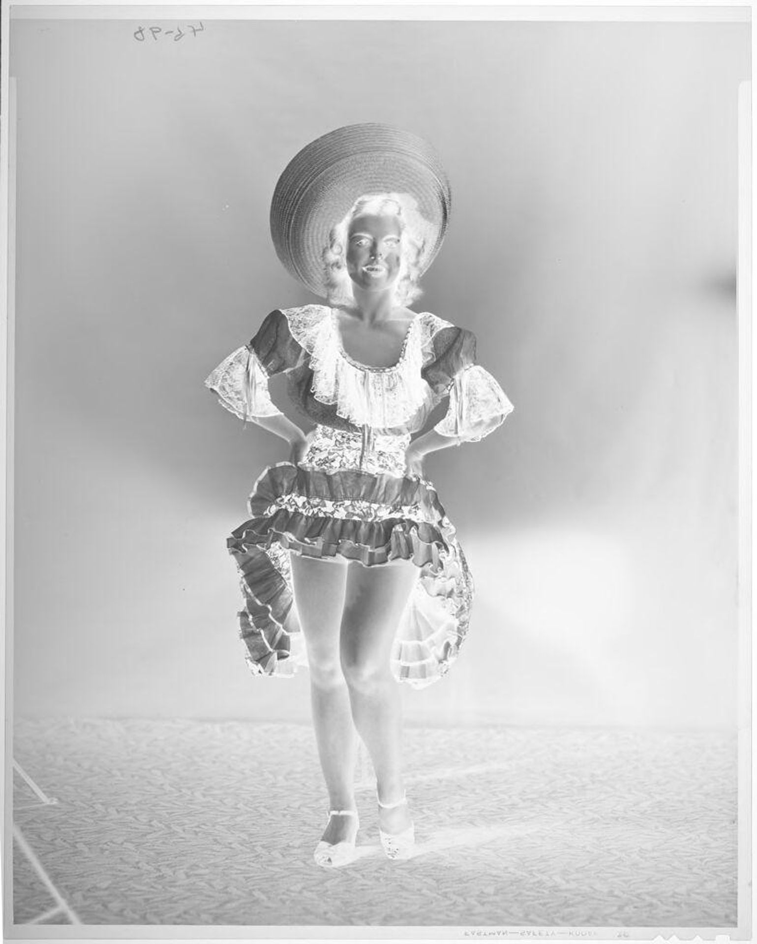 Untitled (woman in sombrero and dancing dress, looking ahead) by John Deusing