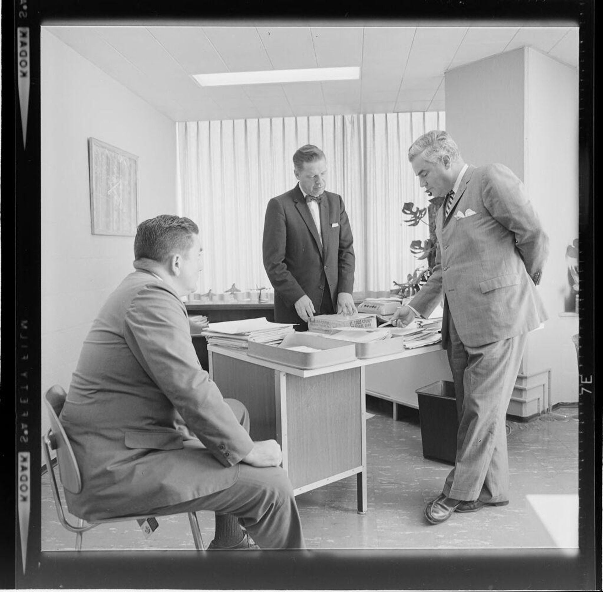 Untitled (three businessmen in office) by Jack Gould