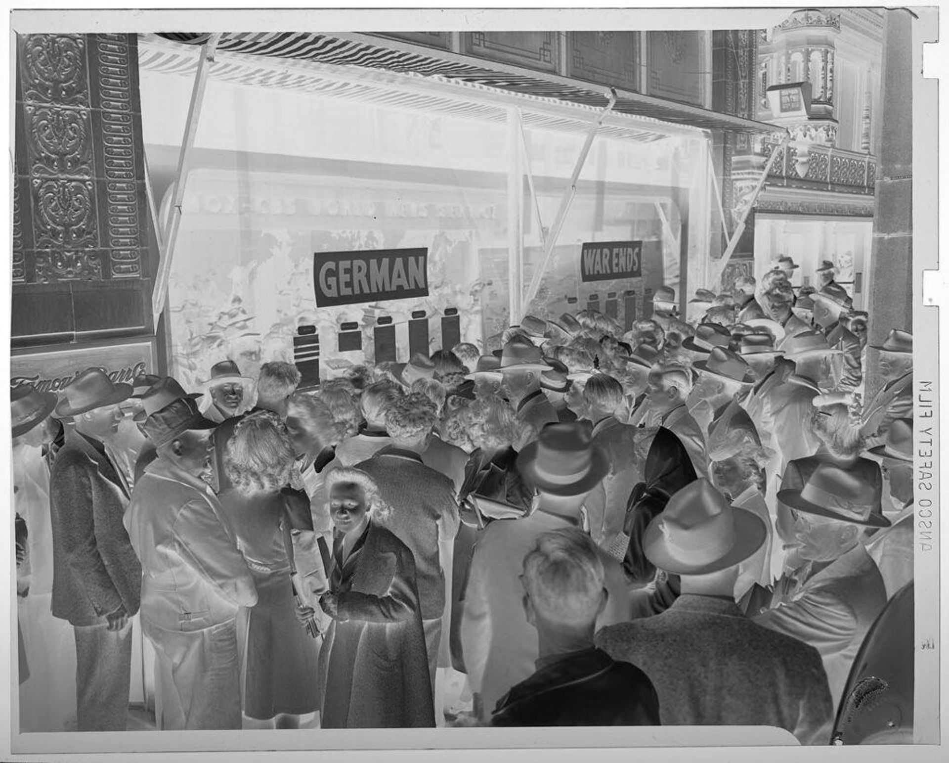 Untitled (VE Day: crowd of people on city street reading news on window) by Jack Gould