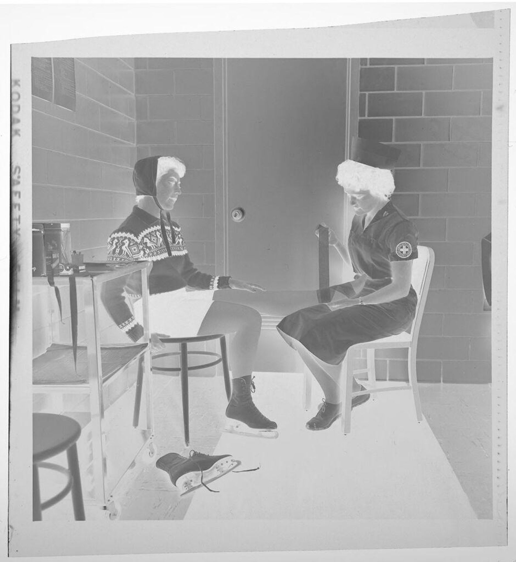 Untitled (nurse wrapping patient's ankle) by Jack Gould