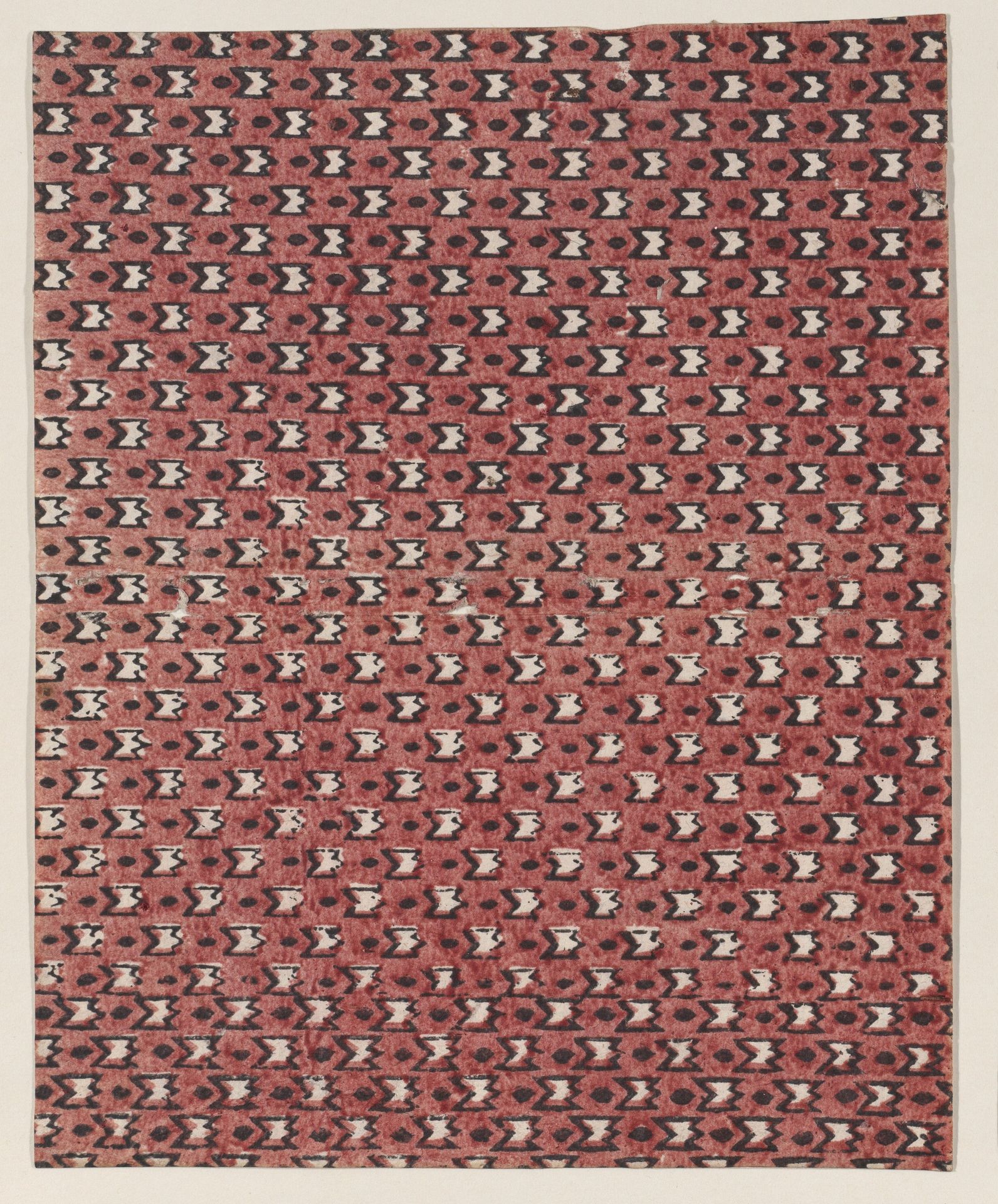 Sheet with overall red and black geometric pattern by Anonymous