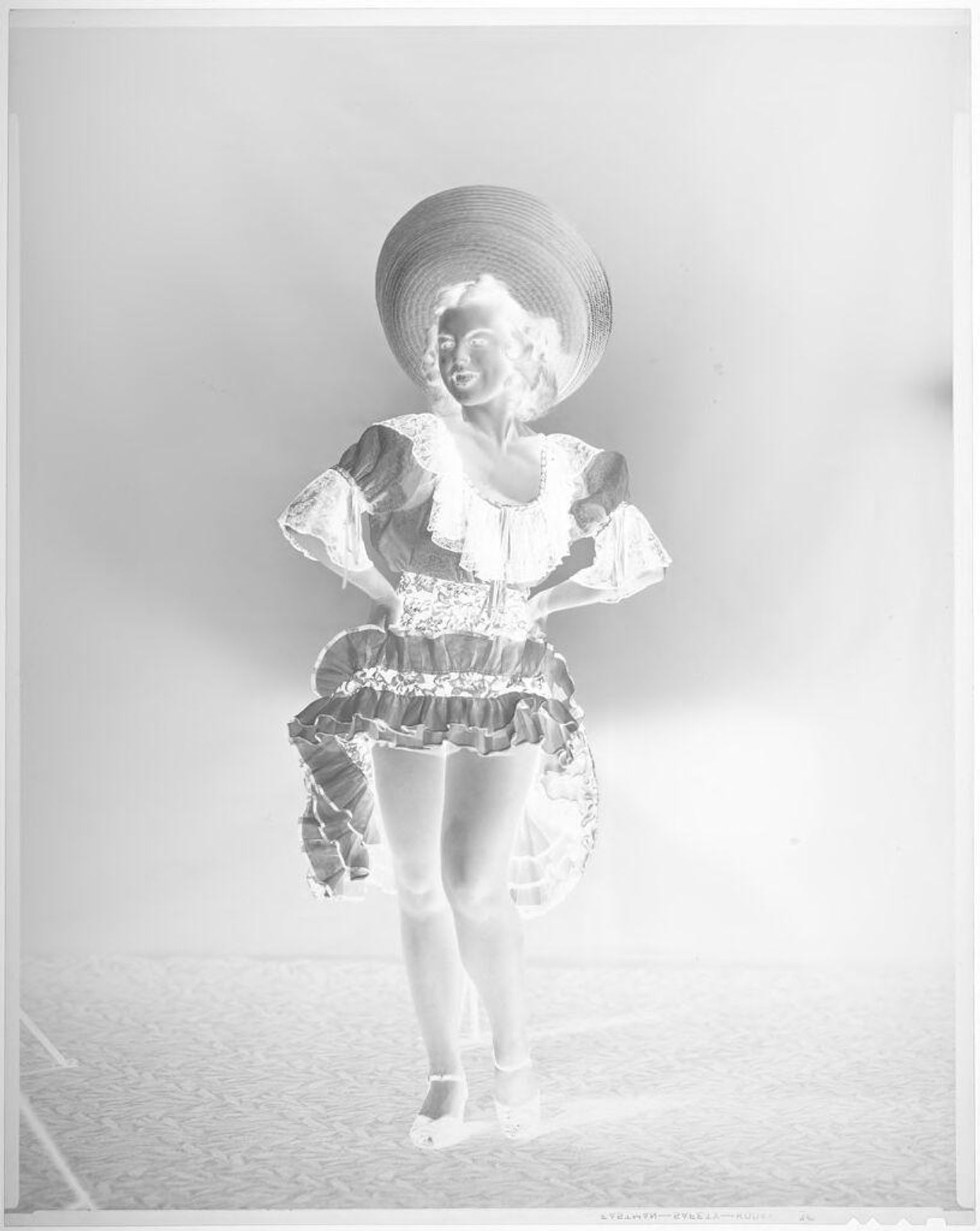 Untitled (woman in sombrero and dancing dress, looking to the side) by John Deusing