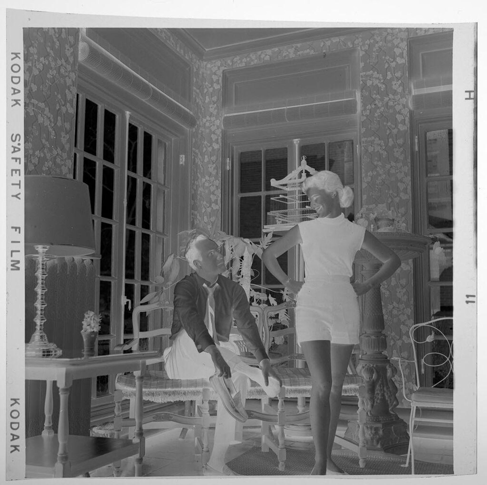 Untitled (seated man and standing women with arms on hips) by Jack Gould