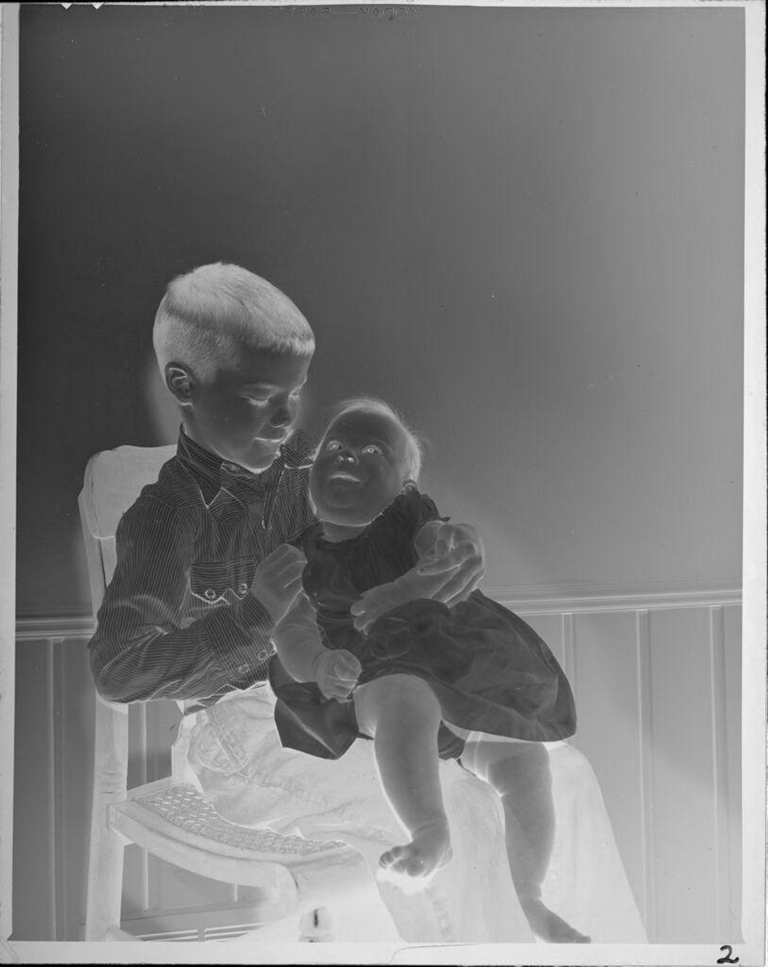 Untitled (boy holding baby) by Lucian and Mary Brown