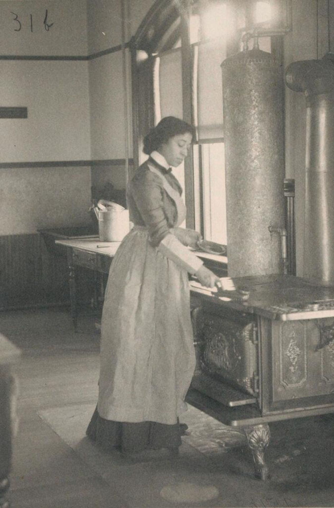 Races, Negroes: United States. Virginia. Hampton. Hampton Normal and Industrial School: Agencies Promoting Assimilation of the Negro. Training Negro Girls in Domestic Science. Hampton Normal and Agricultural Institute, Hampton, Va.: Polishing the Stove. by Frances Benjamin Johnston