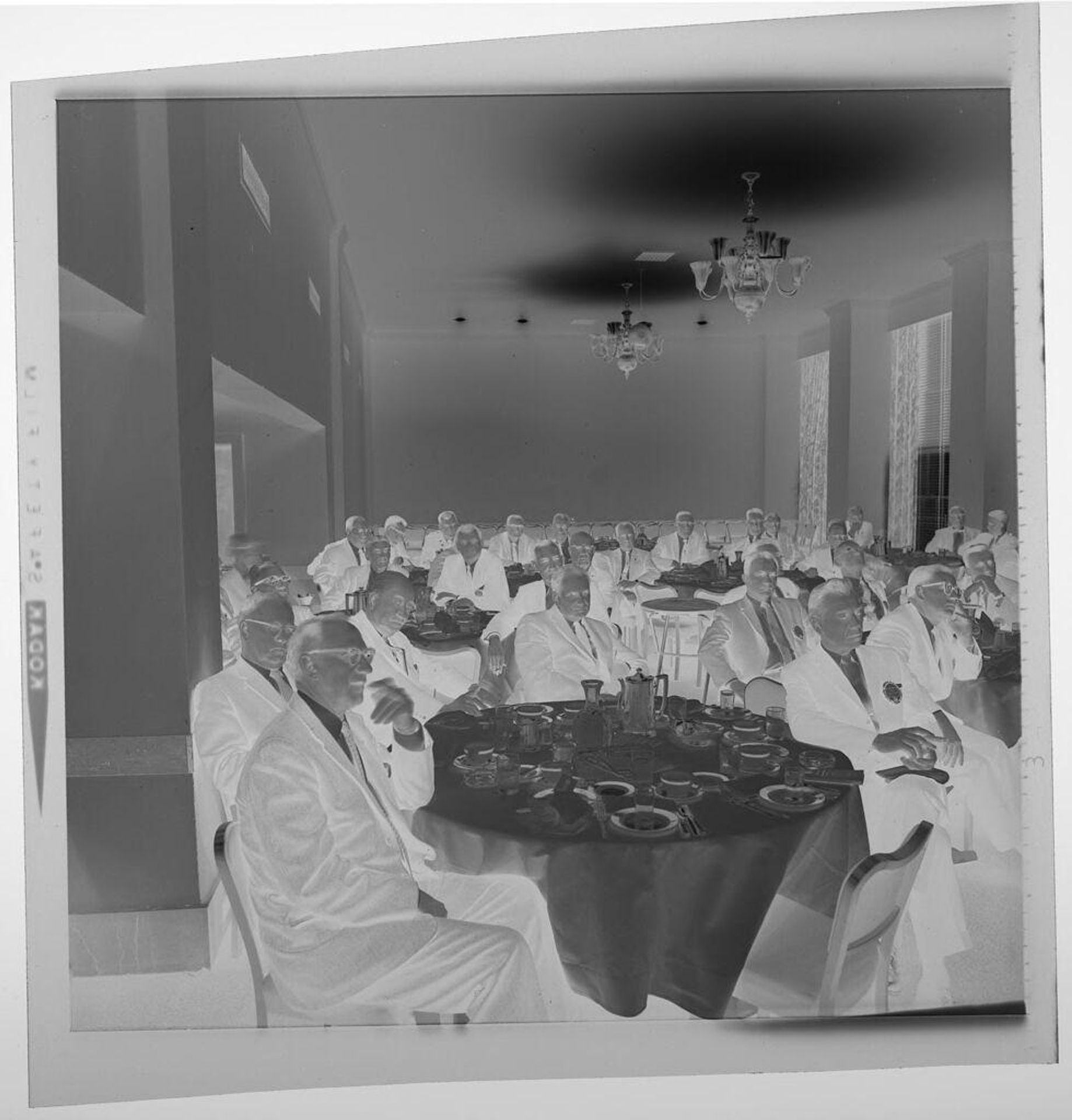 Untitled (large group of men sitting at banquet tables) by Jack Gould