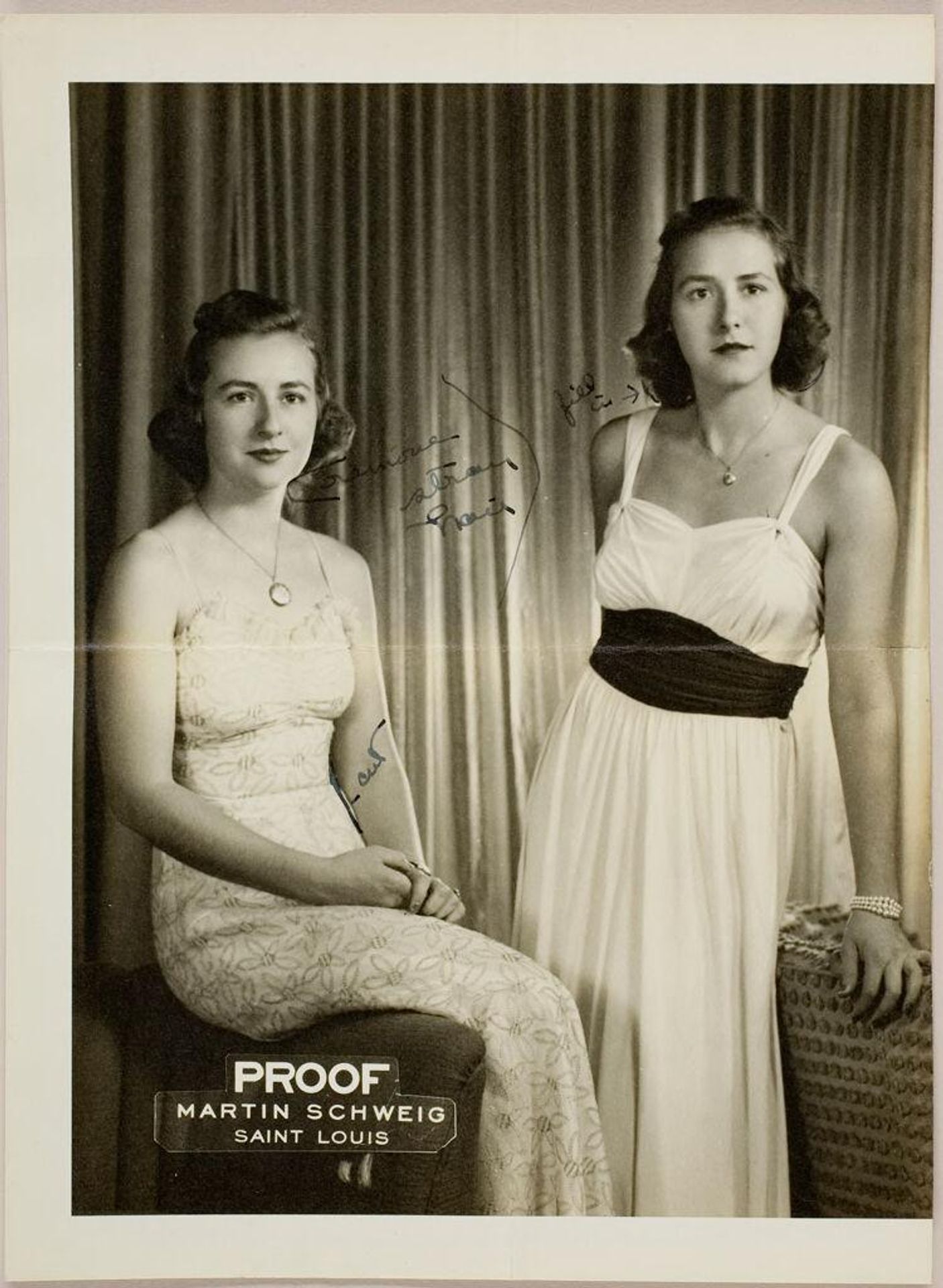 Untitled (studio portrait of two young women in summer dresses sitting on edge of chairs) by Martin Schweig