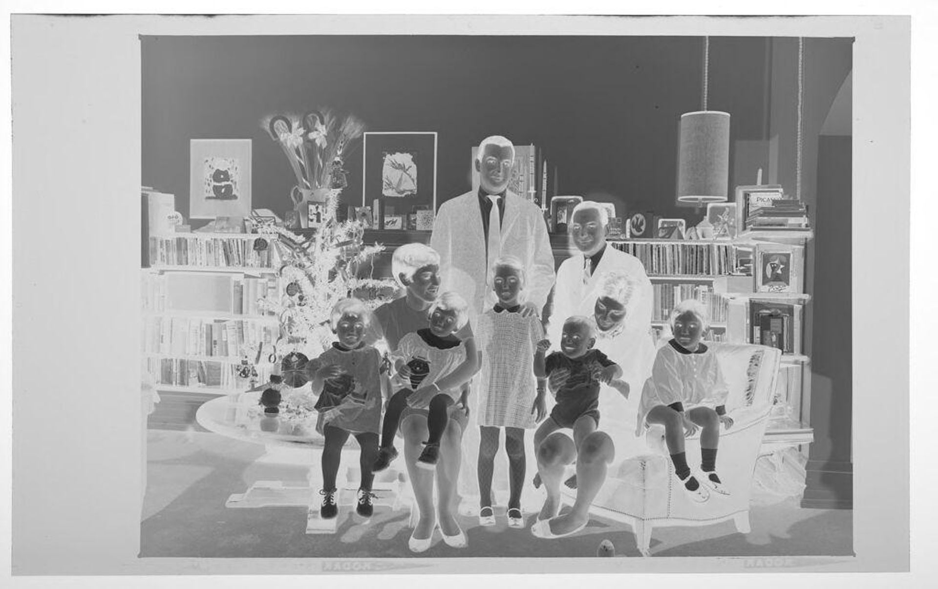Untitled (two families posed in living room decorated for Christmas) by Martin Schweig