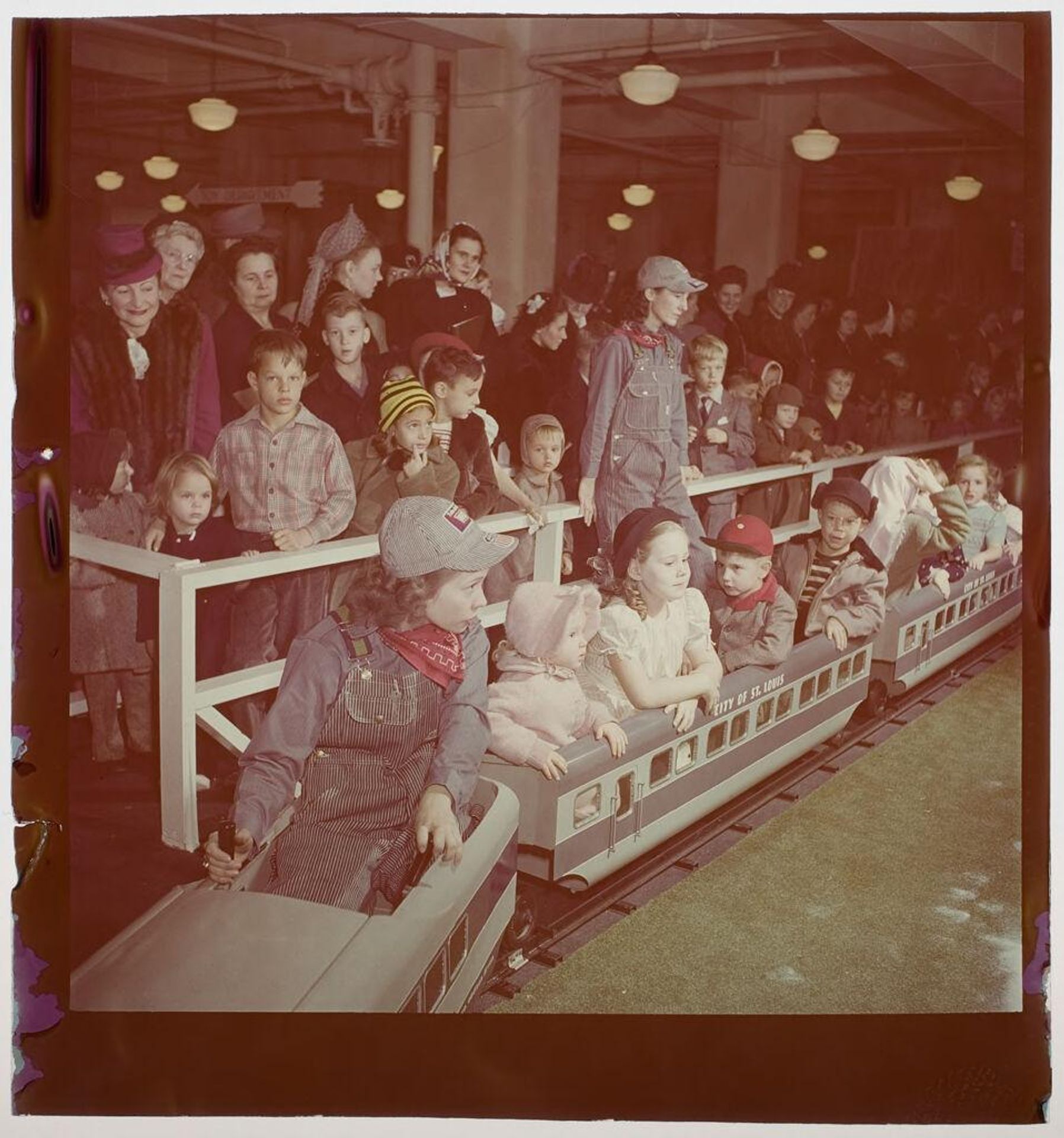 Untitled (children riding on toy train) by Jack Gould