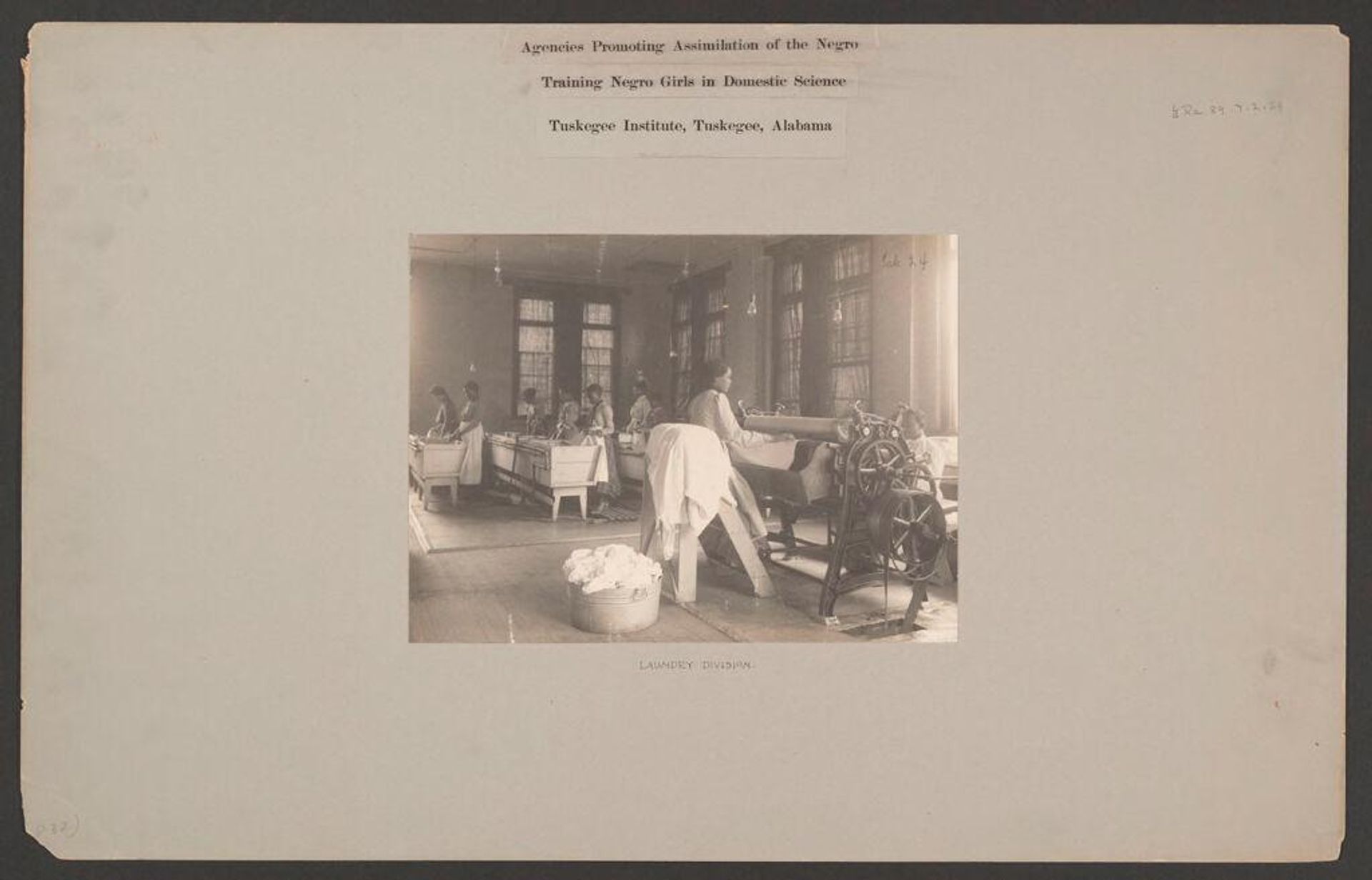 Races, Negroes: United States. Alabama. Tuskegee. Tuskegee Institute: Agencies Promoting Assimilation of the Negro. Training Negro Girls in Domestic Science. Tuskegee Institute, Tuskegee, Alabama: Laundry Division. by ? Frances Benjamin Johnston