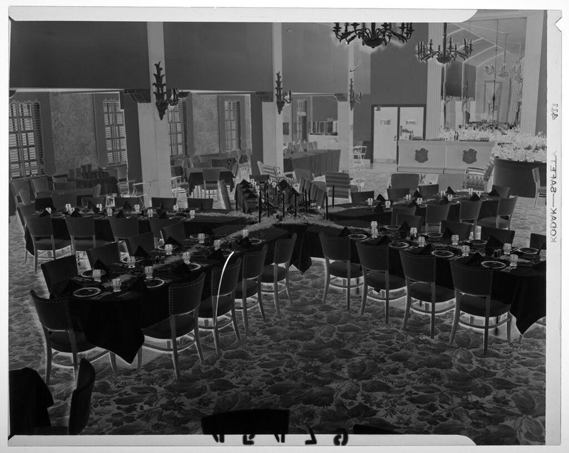 Untitled (elevated view of dining tables in banquet room) by Martin Schweig