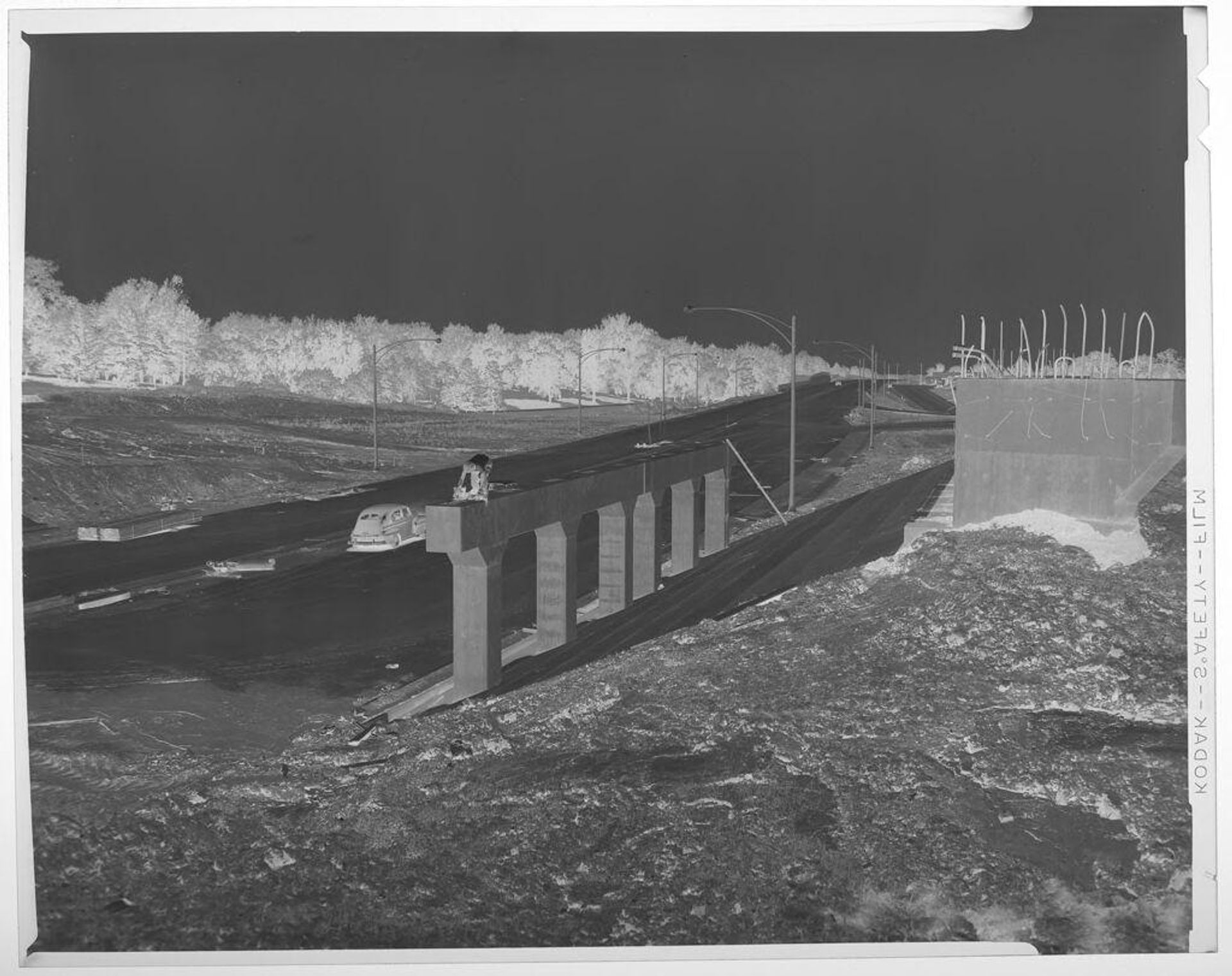 Untitled (man working on highway overpass construction) by Jack Gould