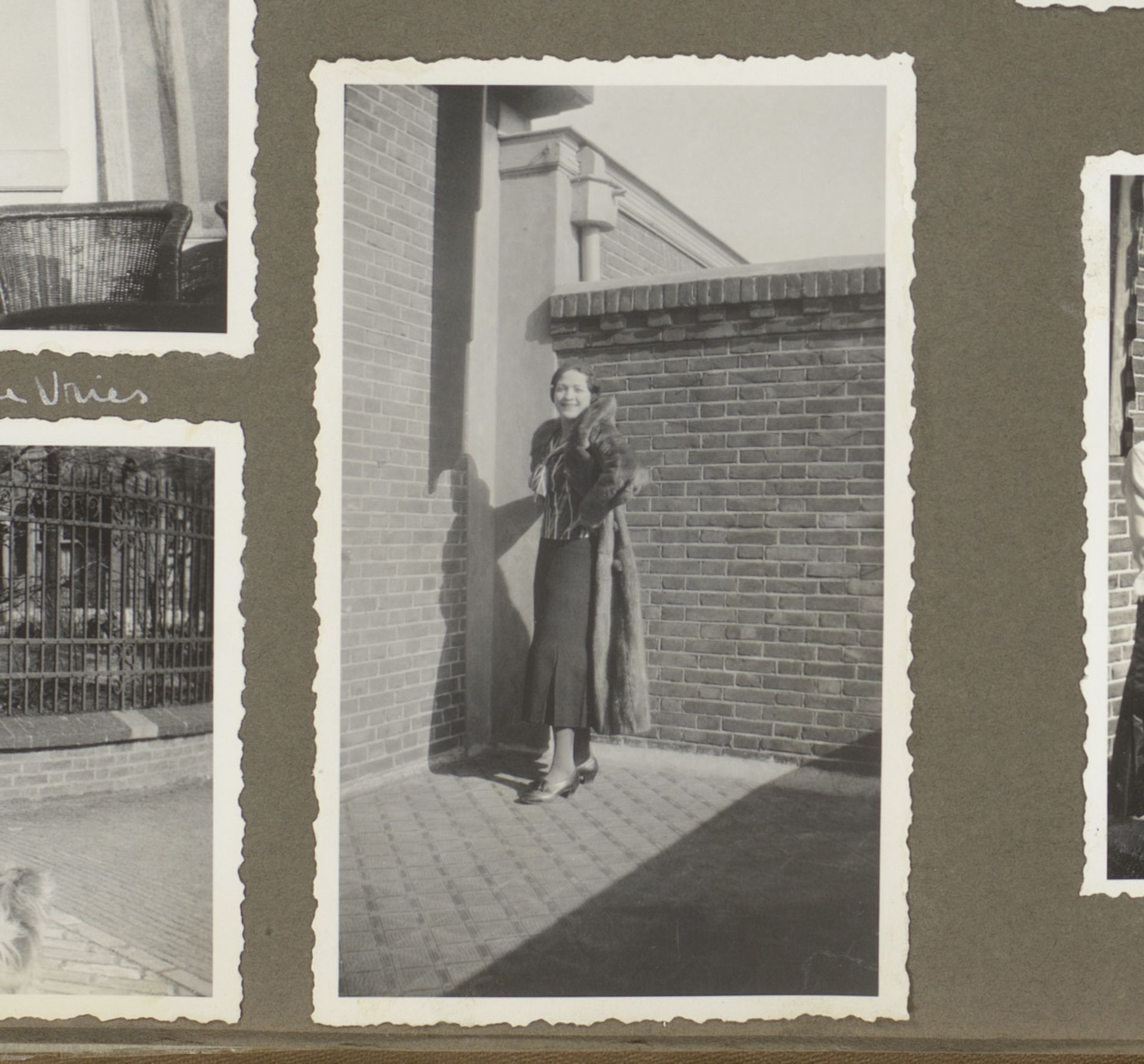 Wilhelmina van Zijll de Jong in een lange jas bij een huis by Anonymous