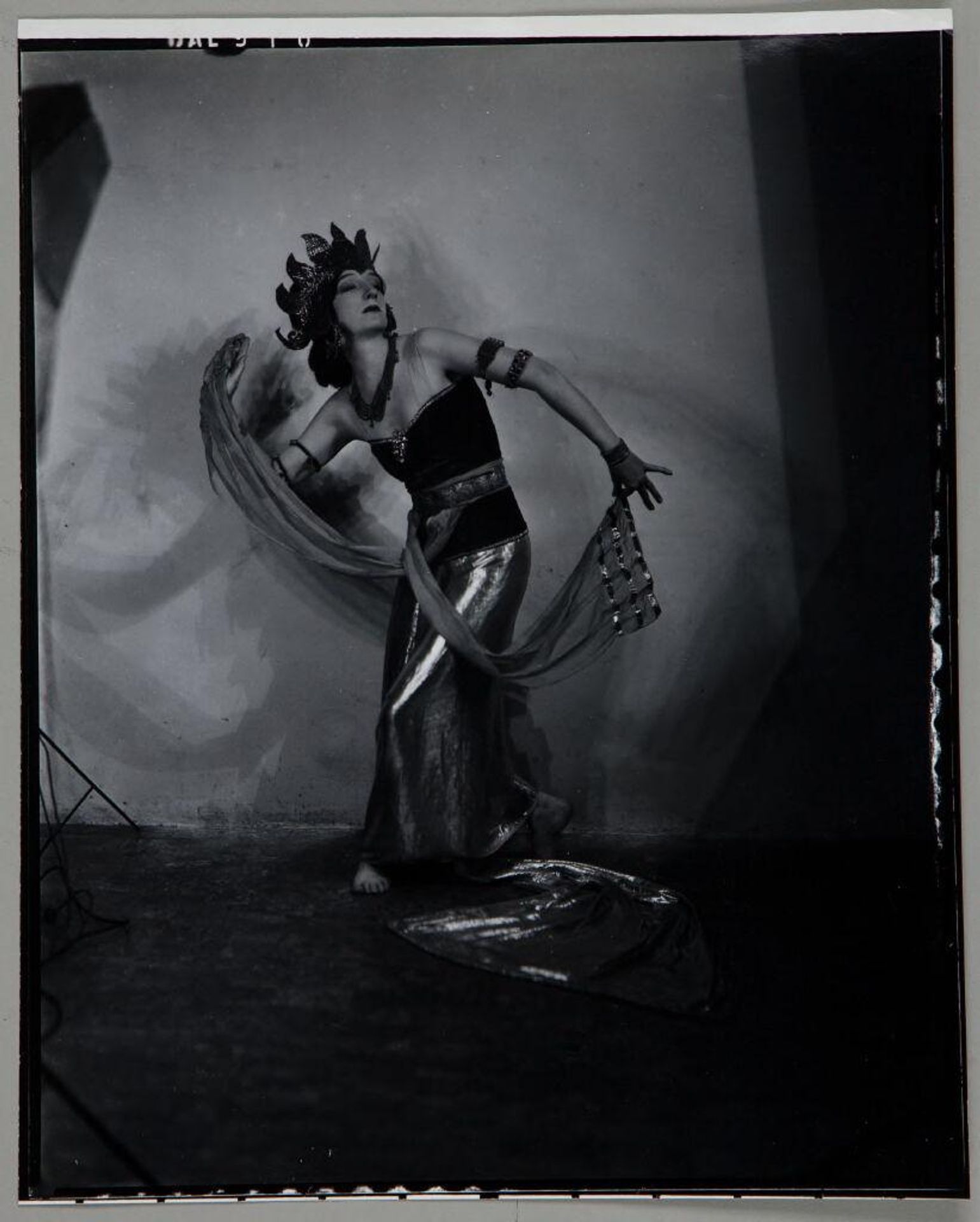 Untitled (woman posing in dance costume with flame-like headdress) by Paul Gittings