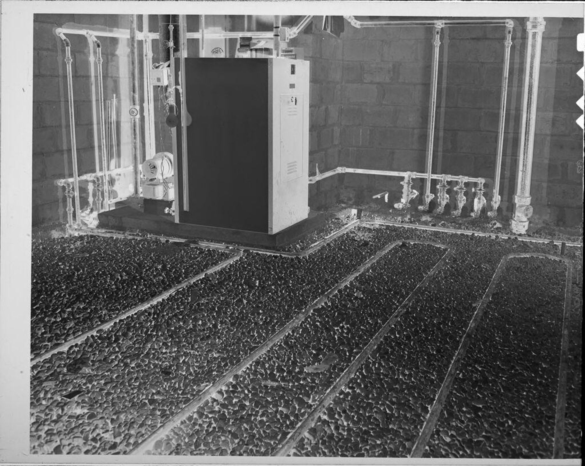 Untitled (gravel floor with pipes) by Lucian and Mary Brown