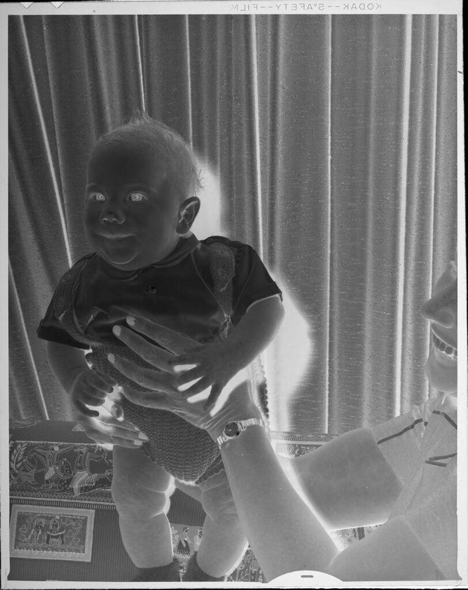 Untitled (baby being held up in air) by Lucian and Mary Brown