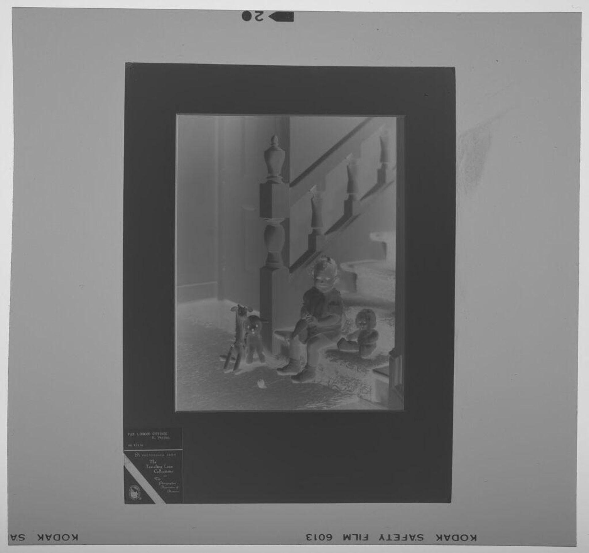Untitled (photograph of child seated on stairs with toys) by Paul Gittings